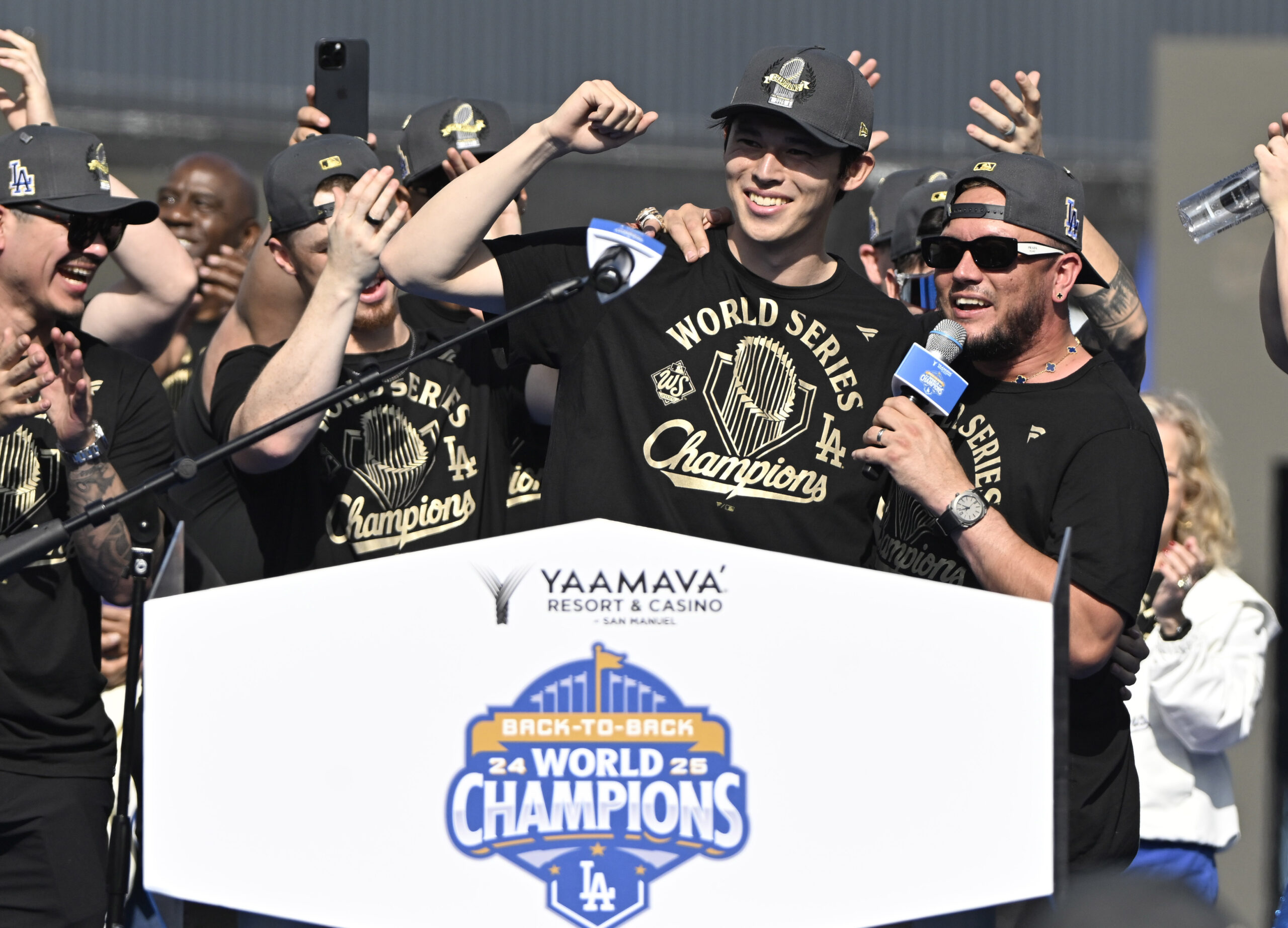 Roki Sasaki, left, with Miguel Rojas of the Los Angeles...