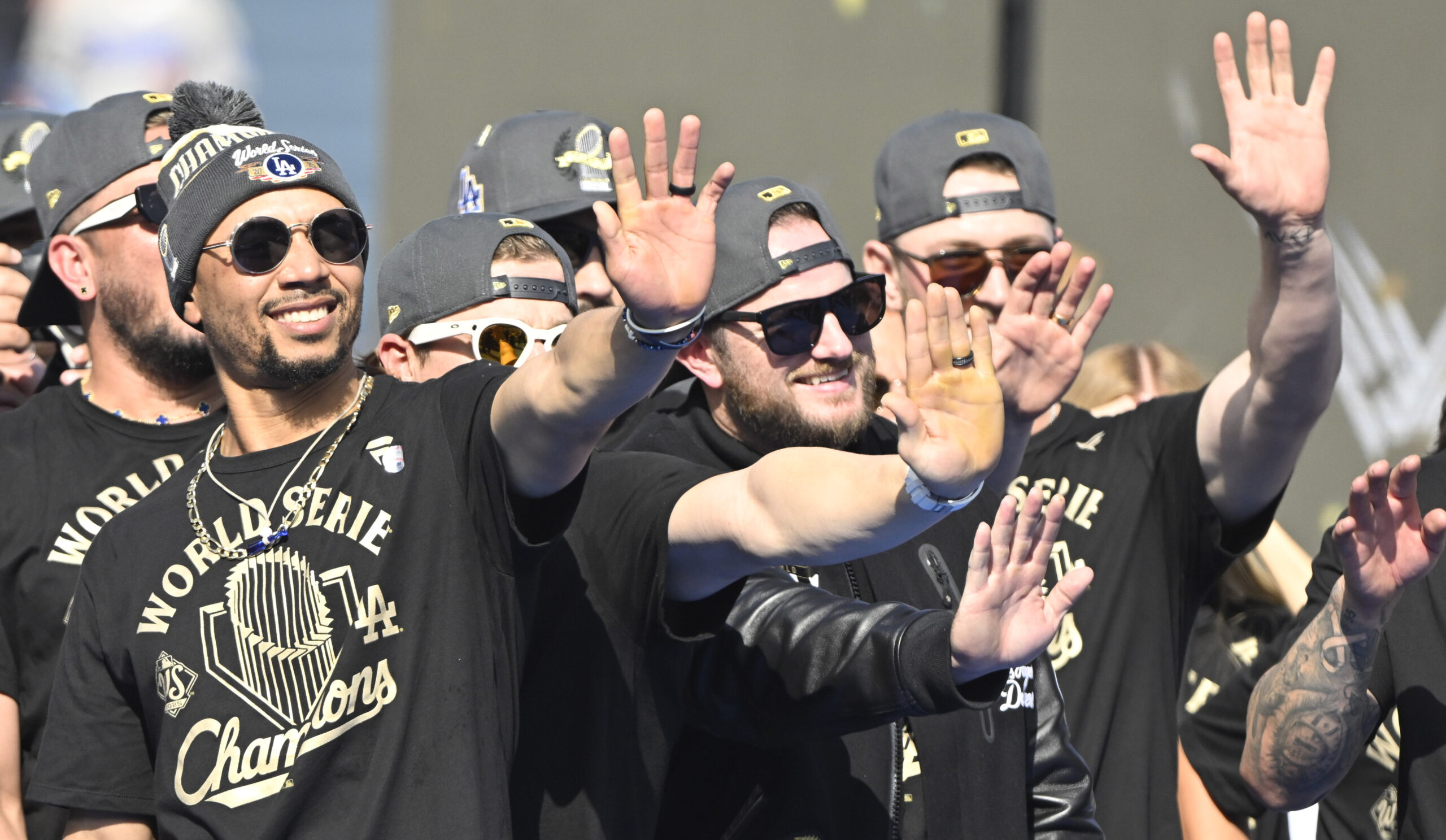 Dodgers shortstop Mookie Betts, left, third baseman Max Muncy, center,...