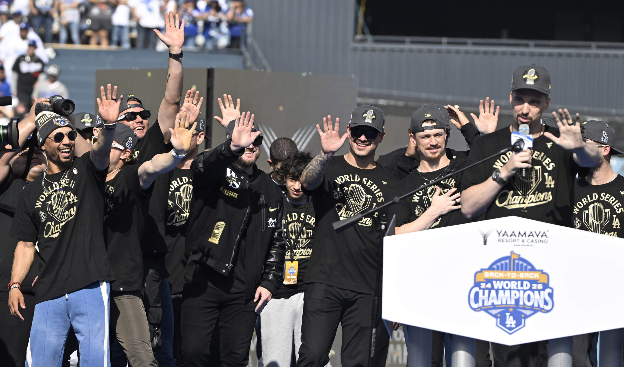 Mookie Betts along with Max Muncy and teammates holds of...