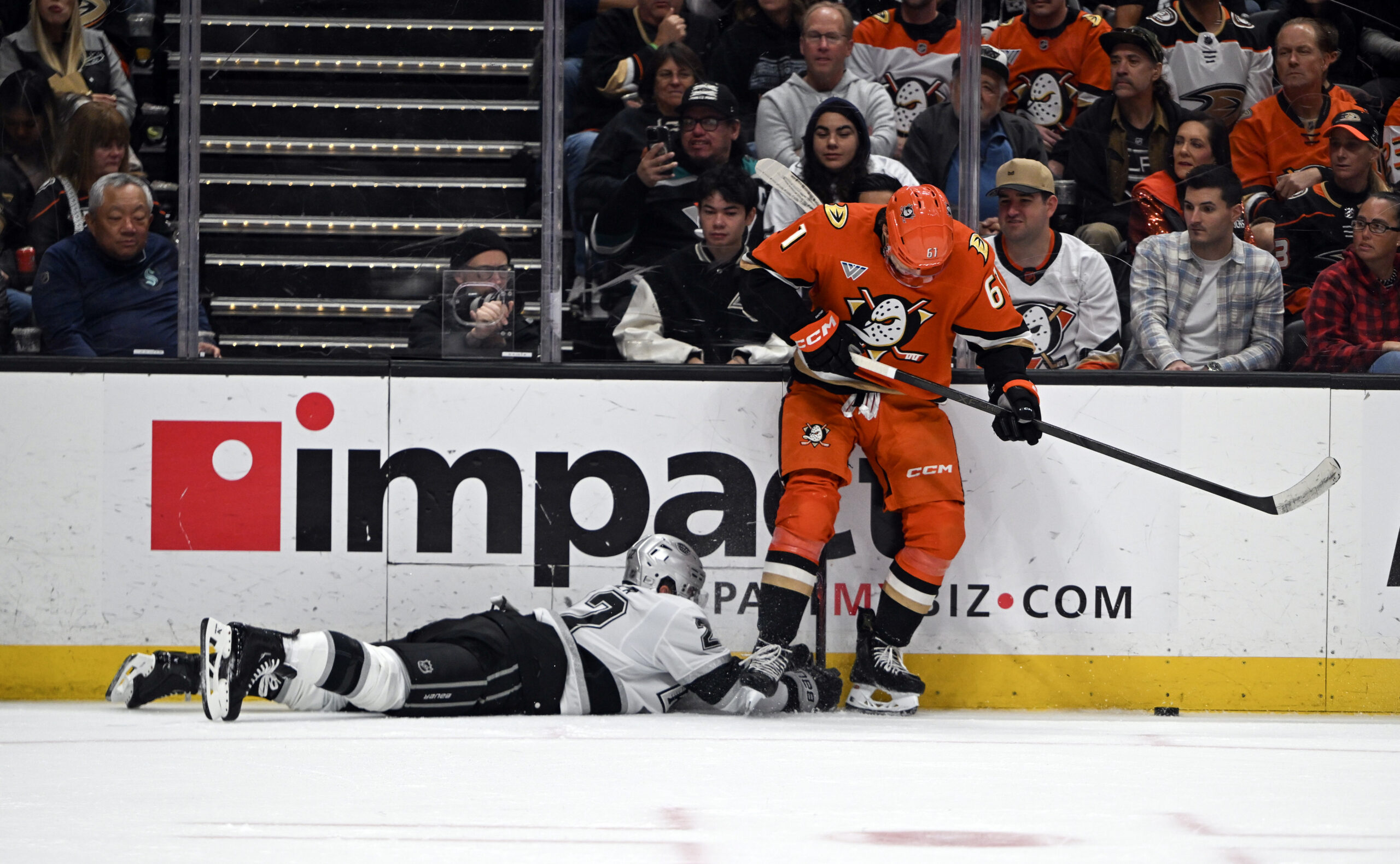The Kings’ Brian Dumoulin dives for the puck as the...