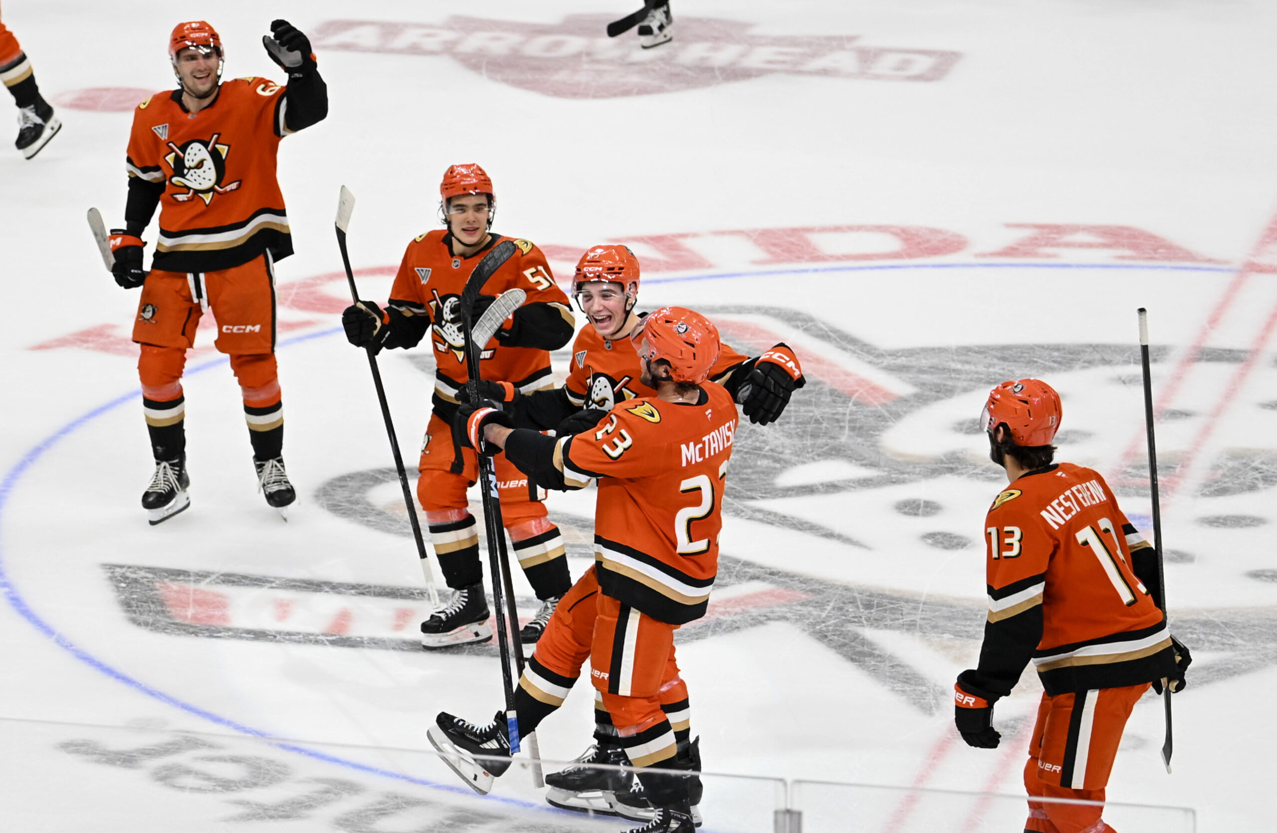 Ducks players, including Mason McTavish (23) celebrate after their 5-4...
