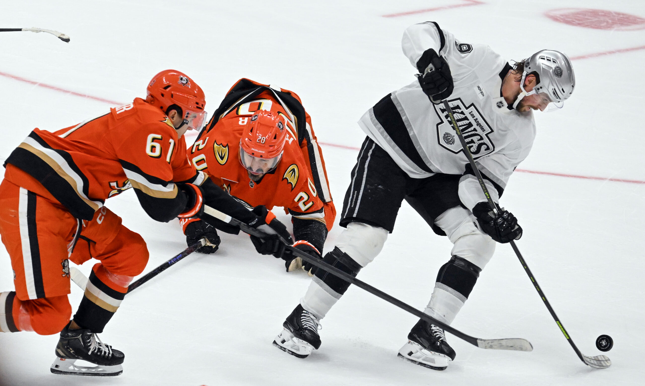 The Ducks’ Cutter Gauthier (61) and Jansen Harkins (24) try...