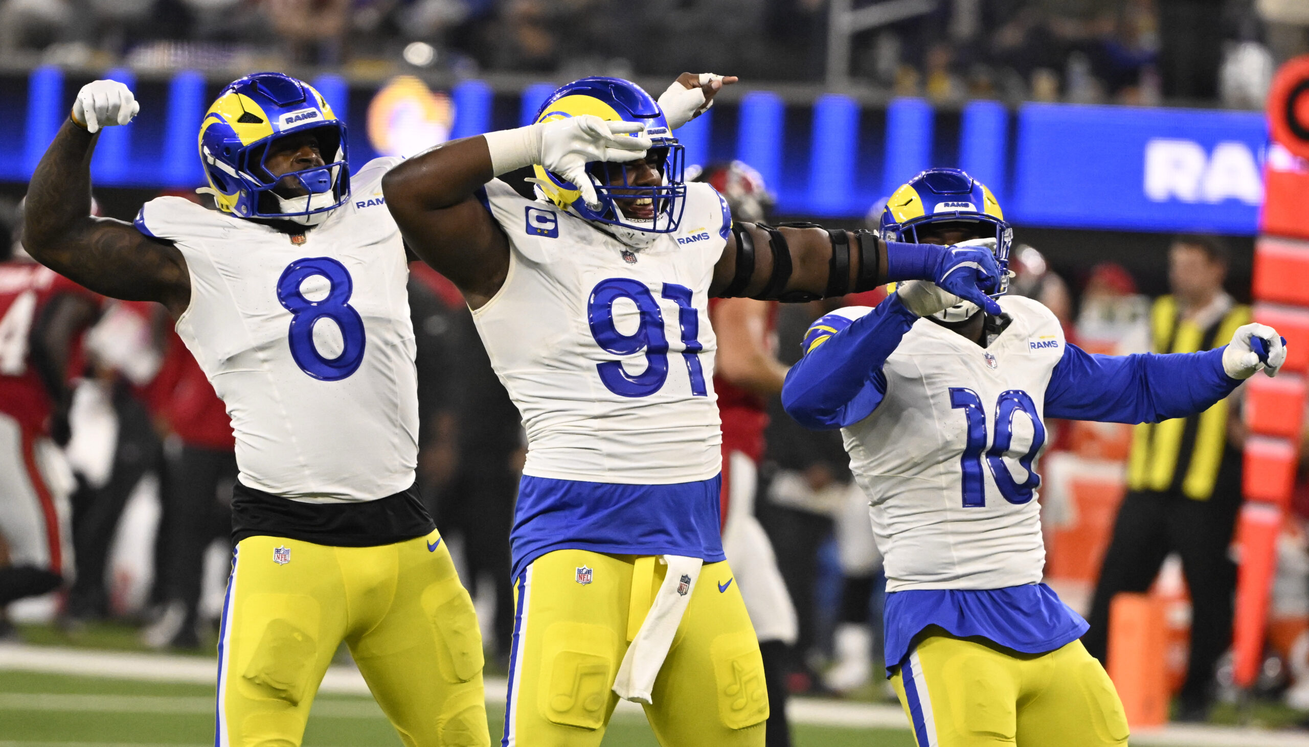 Defensive end Kobie Turner (91) reacts with teammates linebacker Jared...