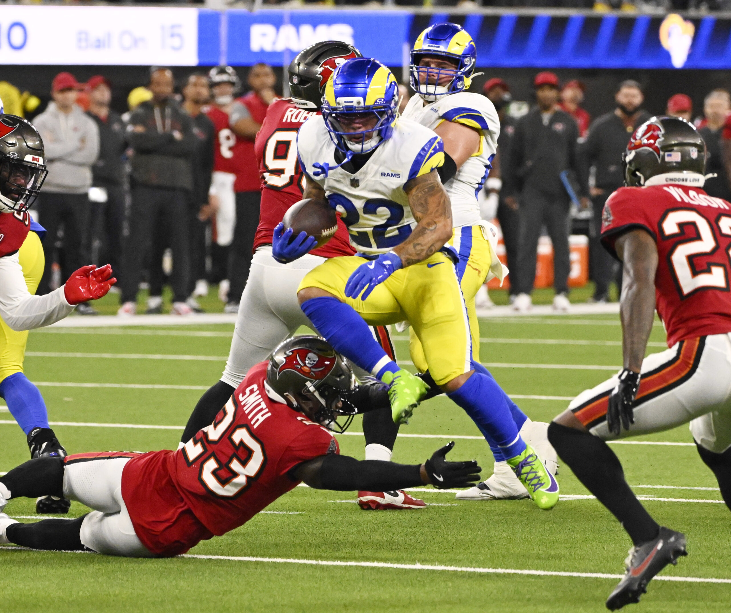 Running back Blake Corum (22) of the Rams leaps over...