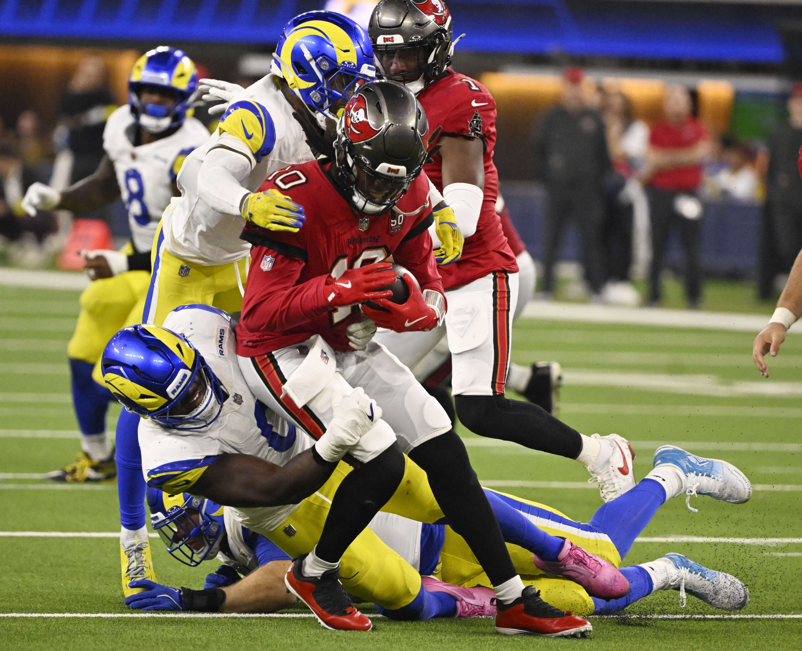 Linebacker Byron Young (0) of the Rams sackes quarterback Teddy...
