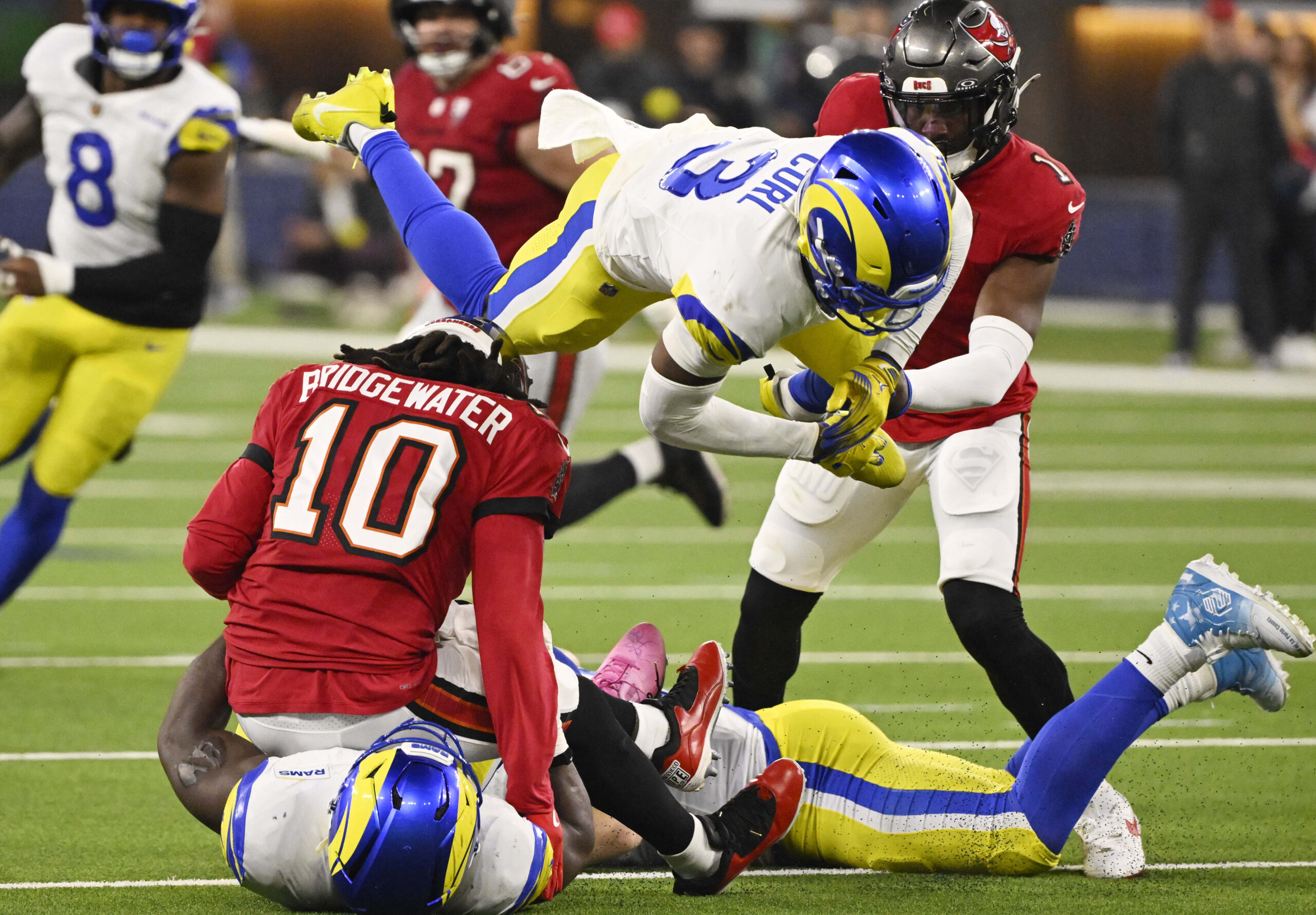 Linebacker Byron Young (0) of the Rams sackes quarterback Teddy...