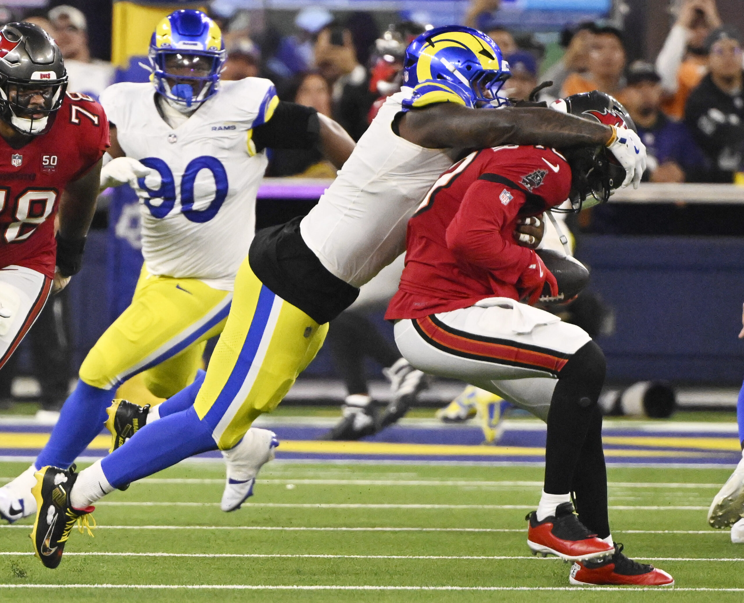 Linebacker Jared Verse (8) of the Rams sacks quarterback Teddy...