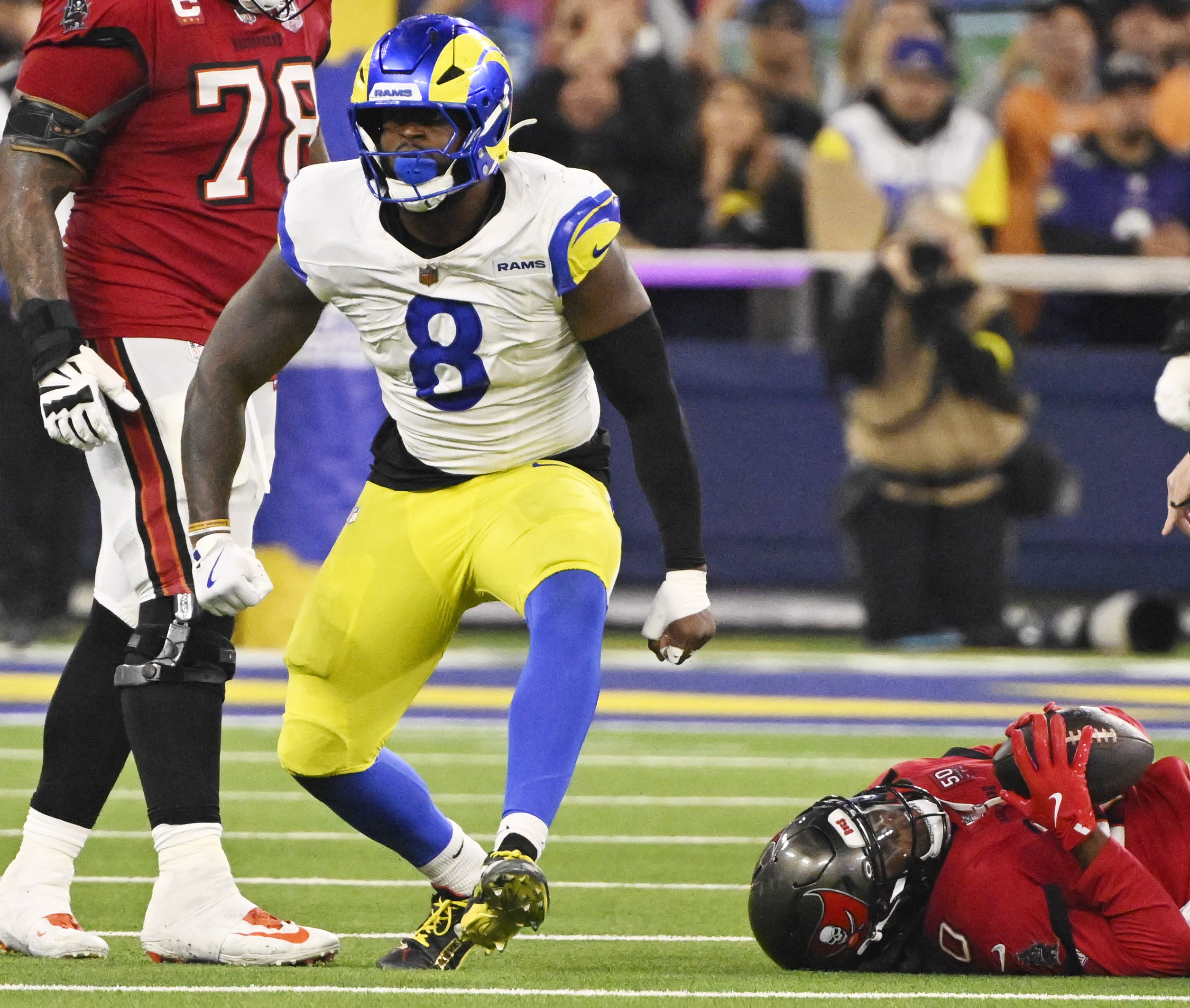 Linebacker Jared Verse (8) of the Rams reacts after sacking...