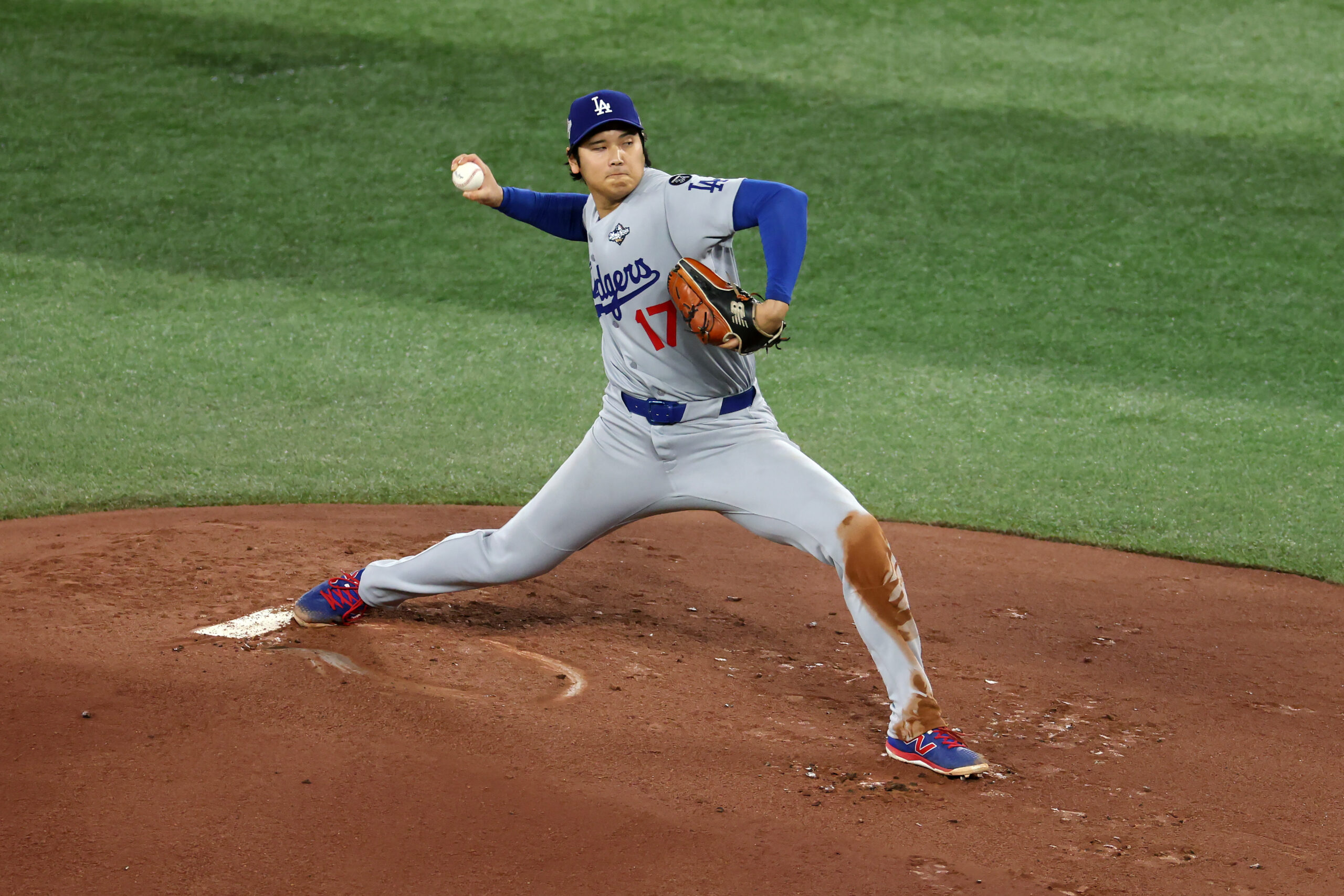 Dodgers starting pitcher Shohei Ohtani throws to the plate during...