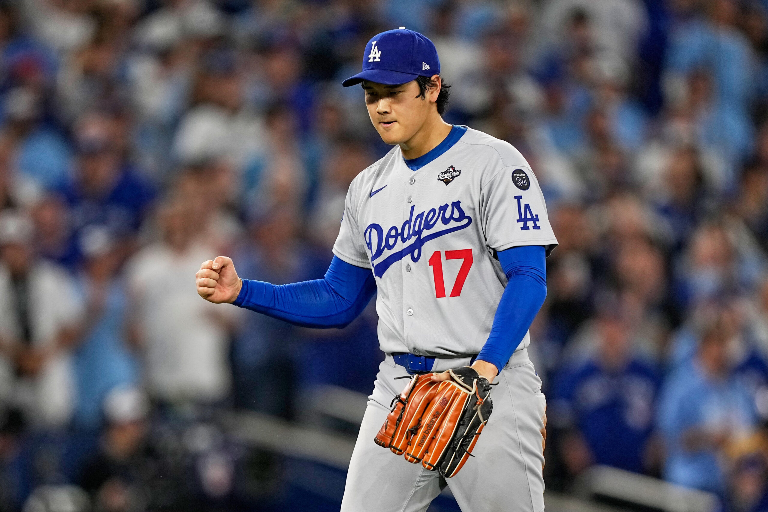 Dodgers starting pitcher Shohei Ohtani celebrates after pitching a scoreless...