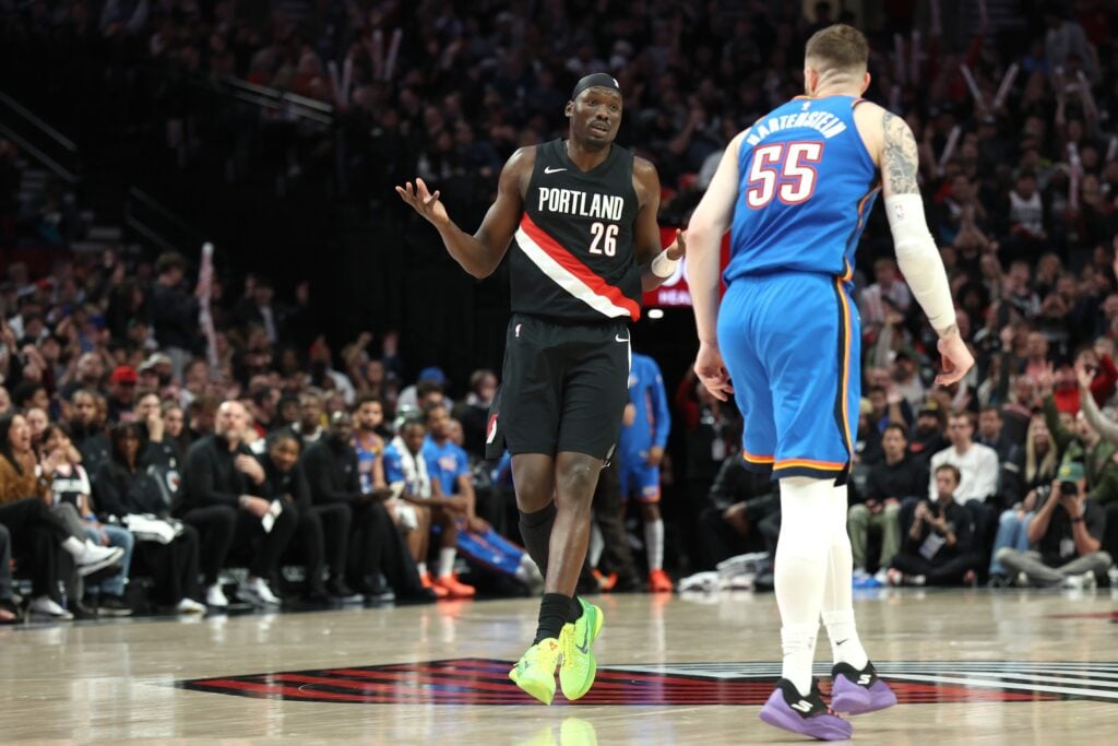 Nov 5, 2025; Portland, Oregon, USA; Portland Trail Blazers center Duop Reath (26) reacts after making a shot against Oklahoma City Thunder center/forward Isaiah Hartenstein (55) during the second half at Moda Center. Mandatory Credit: Jaime Valdez-Imagn Images
