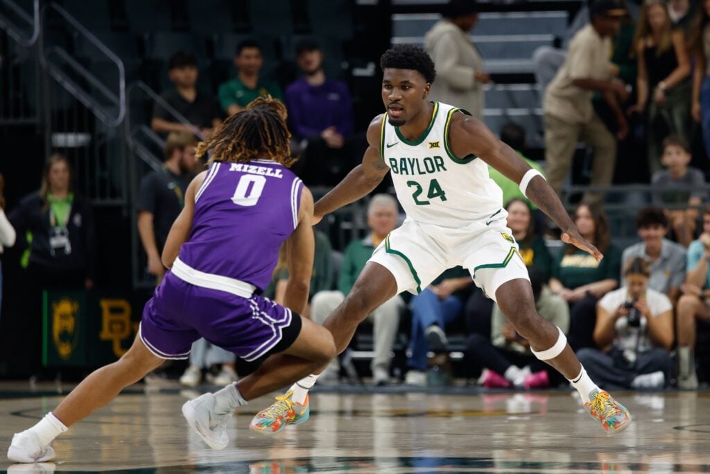 Tarleton State Texans guard Jordan Mizell (0) controls the ball as Baylor Bears guard Tounde Yessoufou (24) defends during the first half at Paul and Alejandra Foster Pavilion.