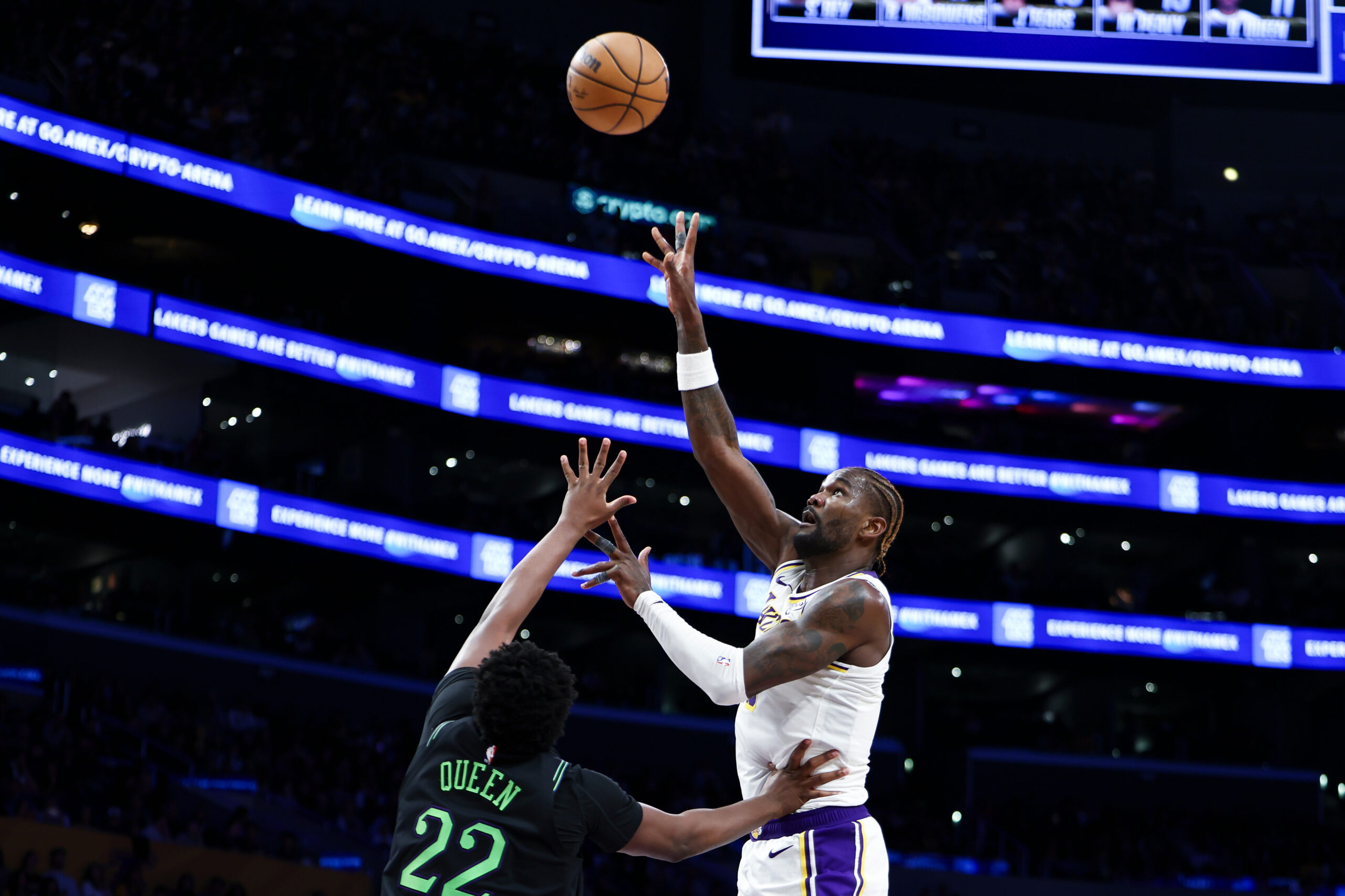 Lakers center Deandre Ayton, right, shoots against New Orleans Pelicans...
