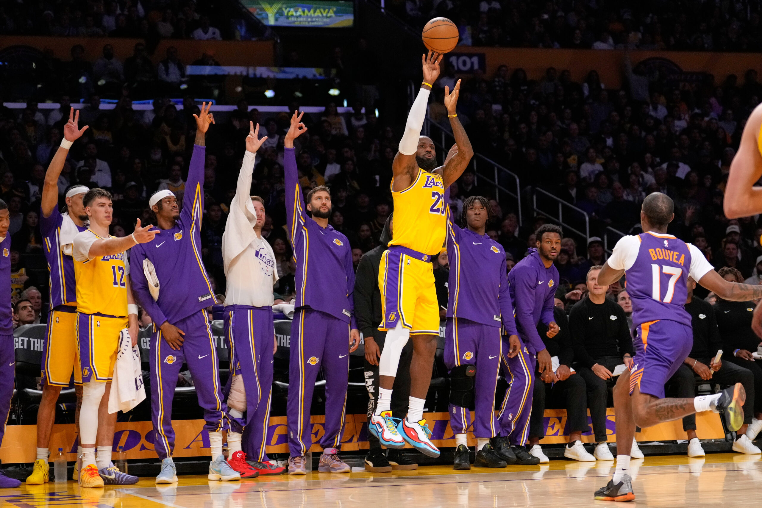 Lakers forward LeBron James, center, takes a 3-point shot as...
