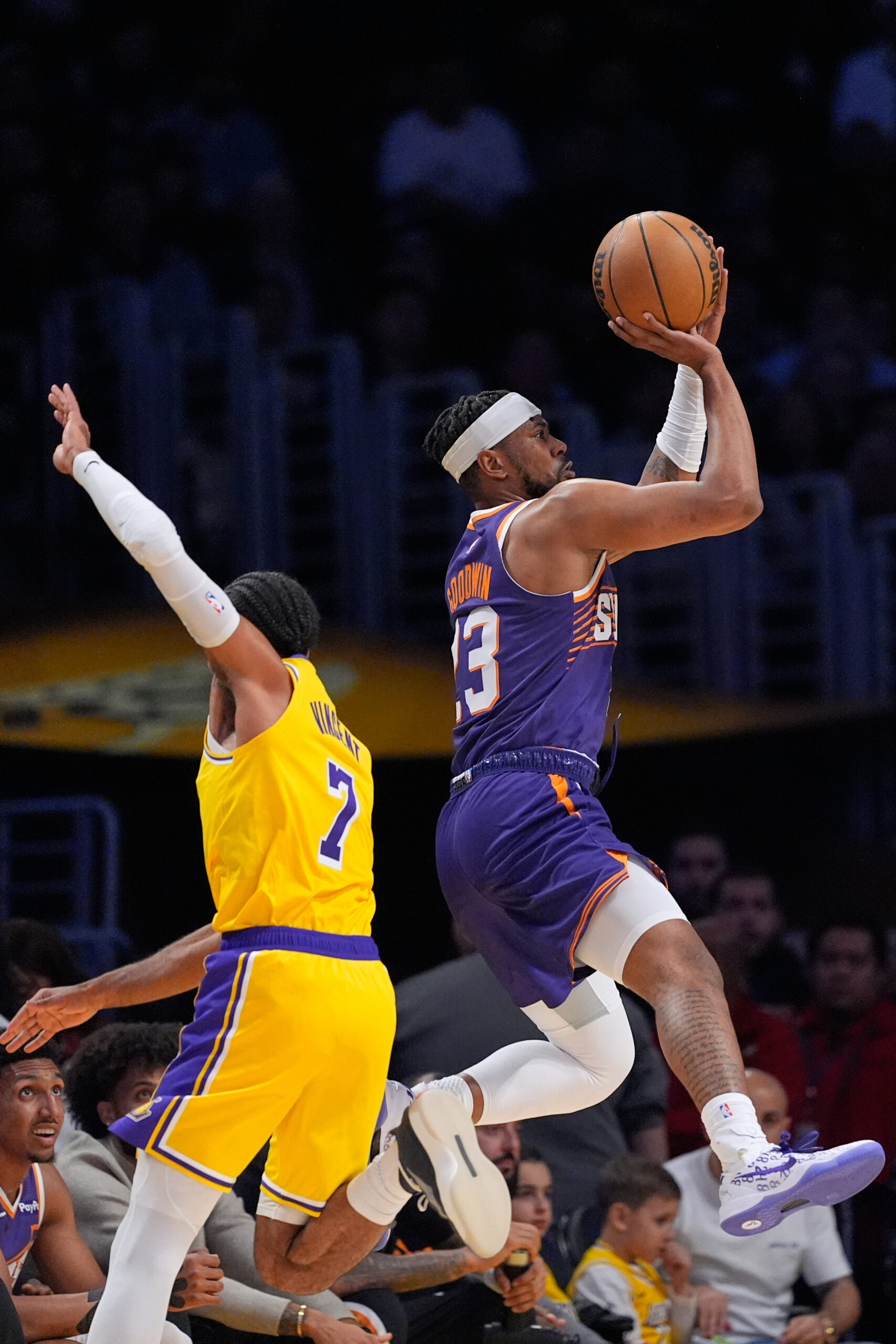 Phoenix Suns guard Jordan Goodwin, right, shoots as Lakers guard...