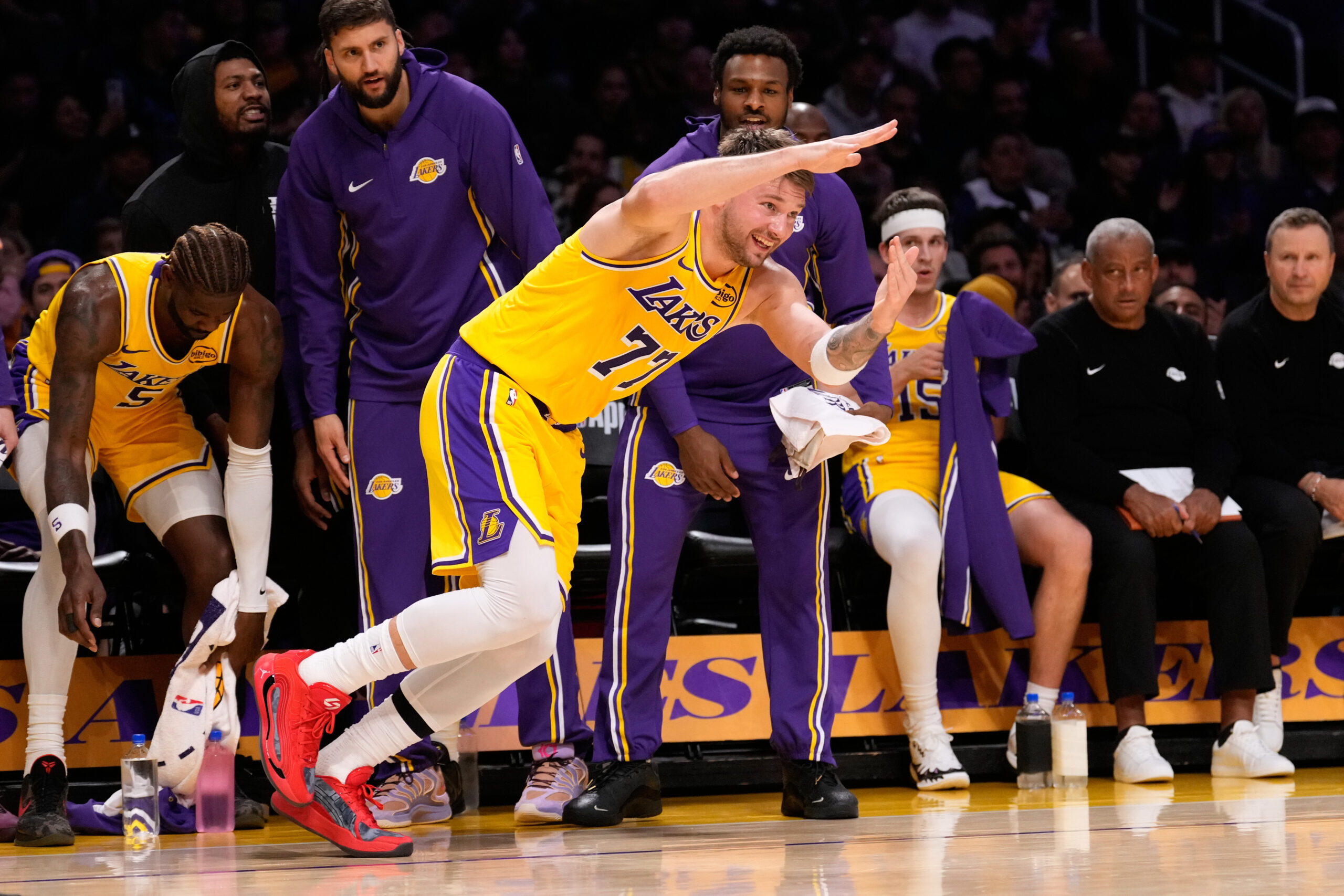 Lakers guard Luka Doncic gestures after making a 3-point shot...
