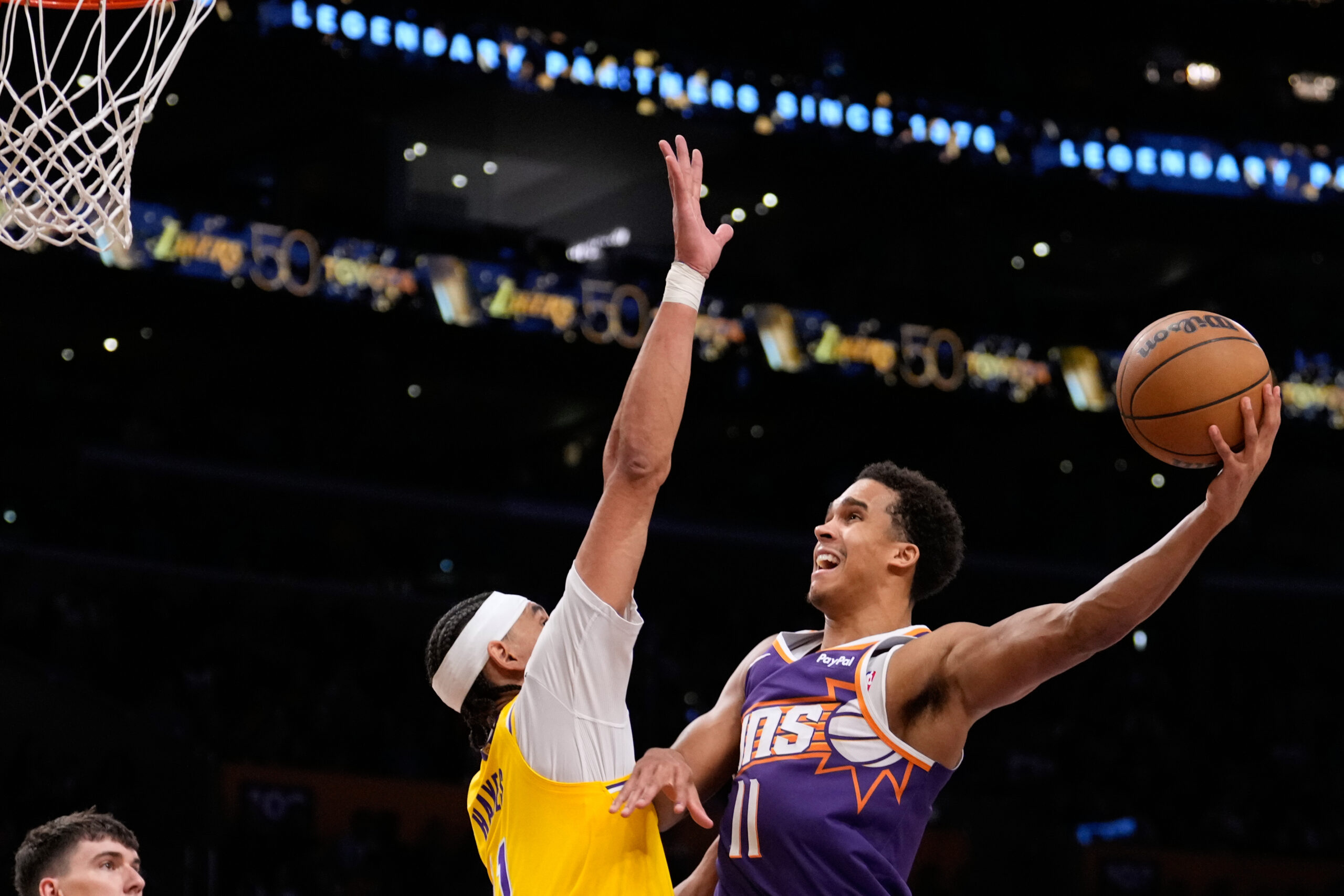 Phoenix Suns forward Oso Ighodaro, right, shoots as Lakers center...