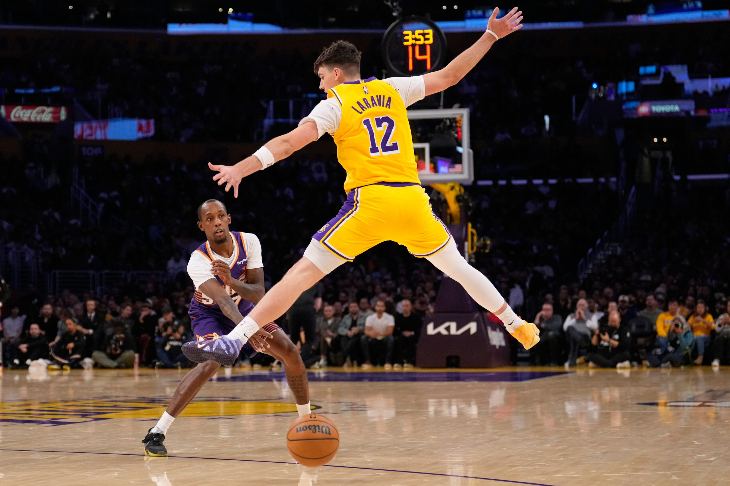 Phoenix Suns guard Jamaree Bouyea, left, passes the ball while...
