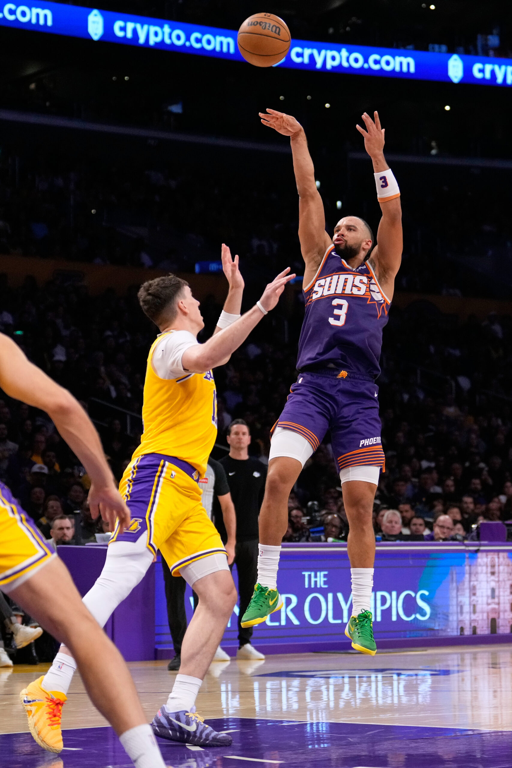 Phoenix Suns forward Dillon Brooks, right, shoots as Lakers forward...