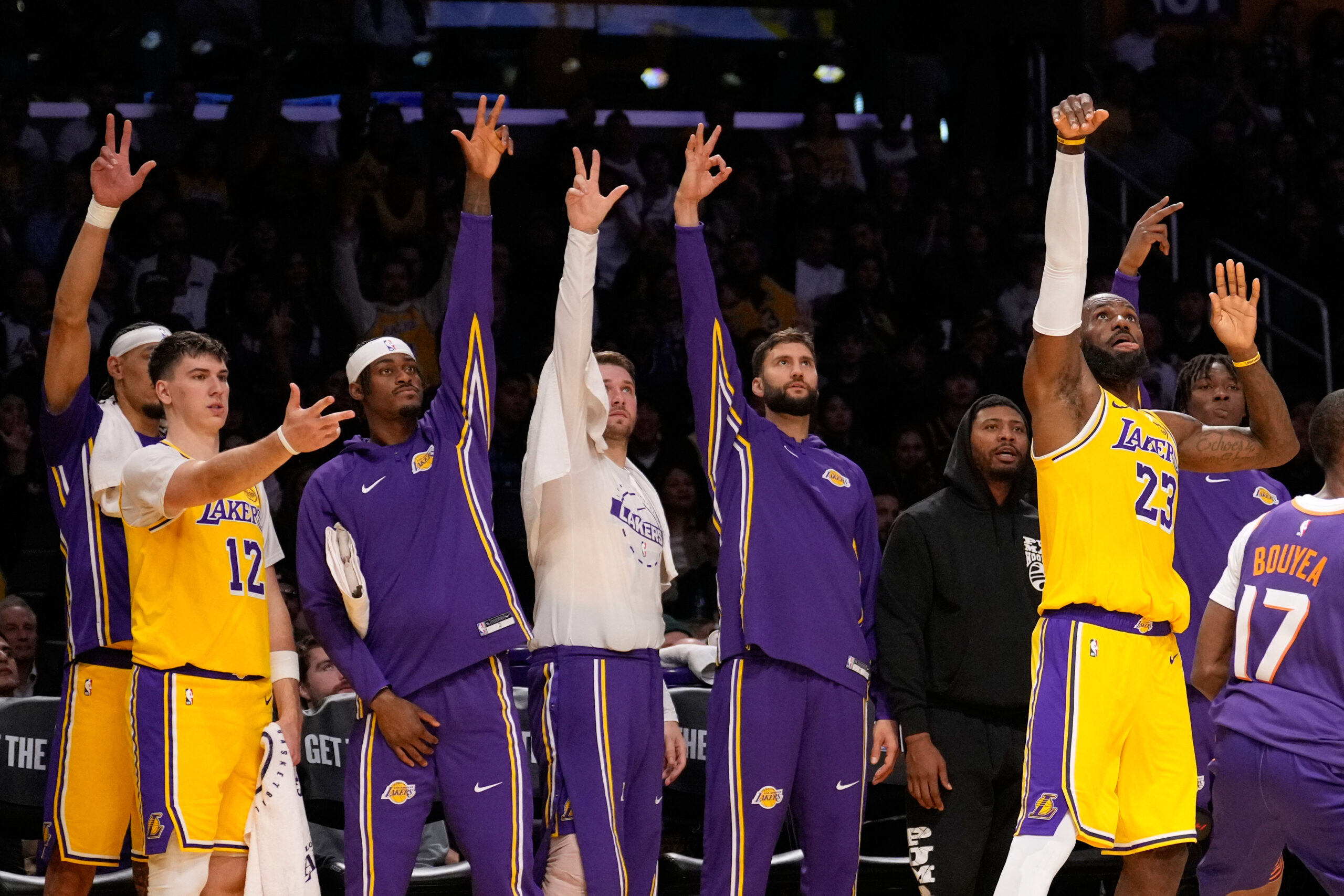 Lakers forward LeBron James, right, takes a 3-point shot as...