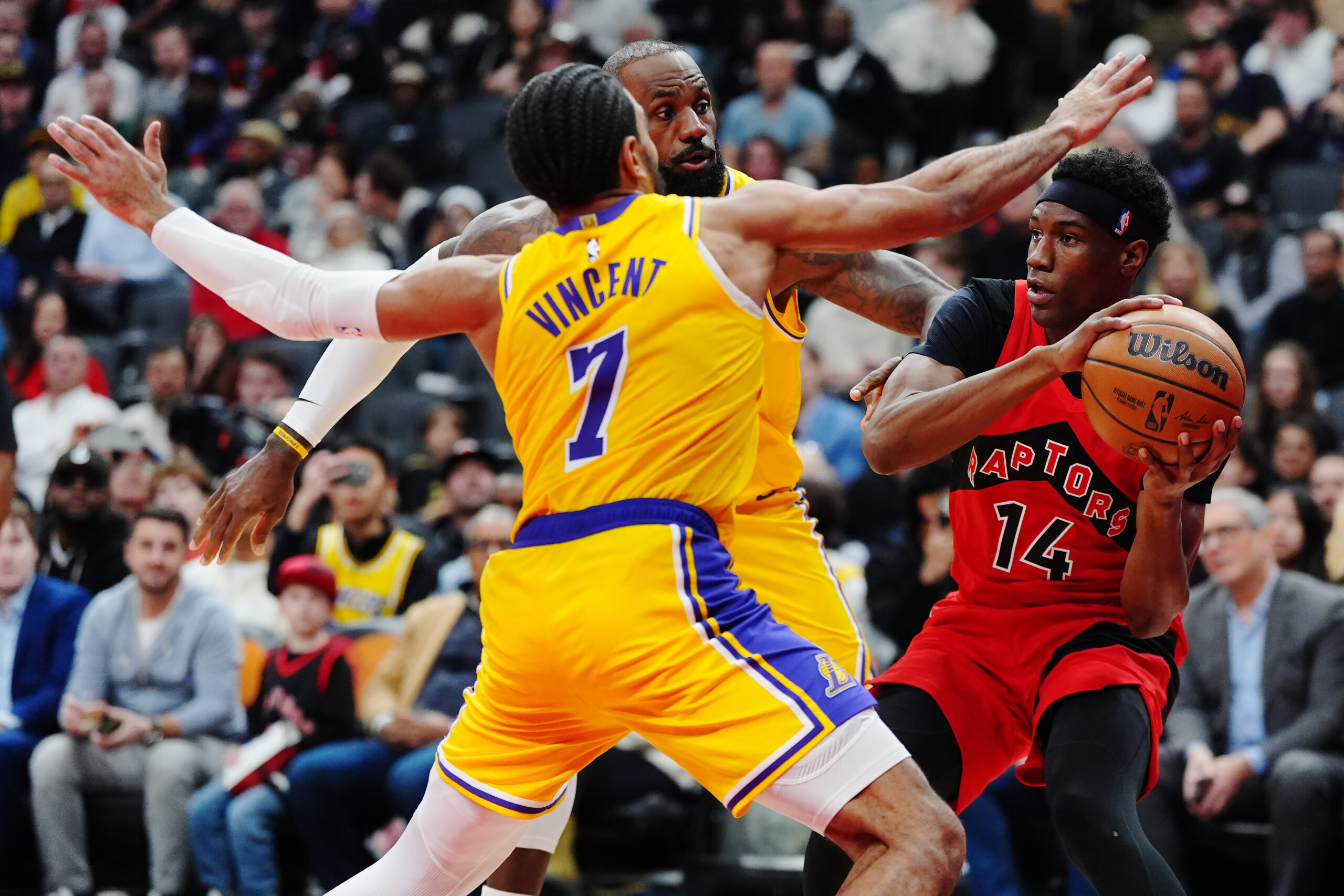 The Toronto Raptors’ Ja’Kobe Walter looks to pass the ball...