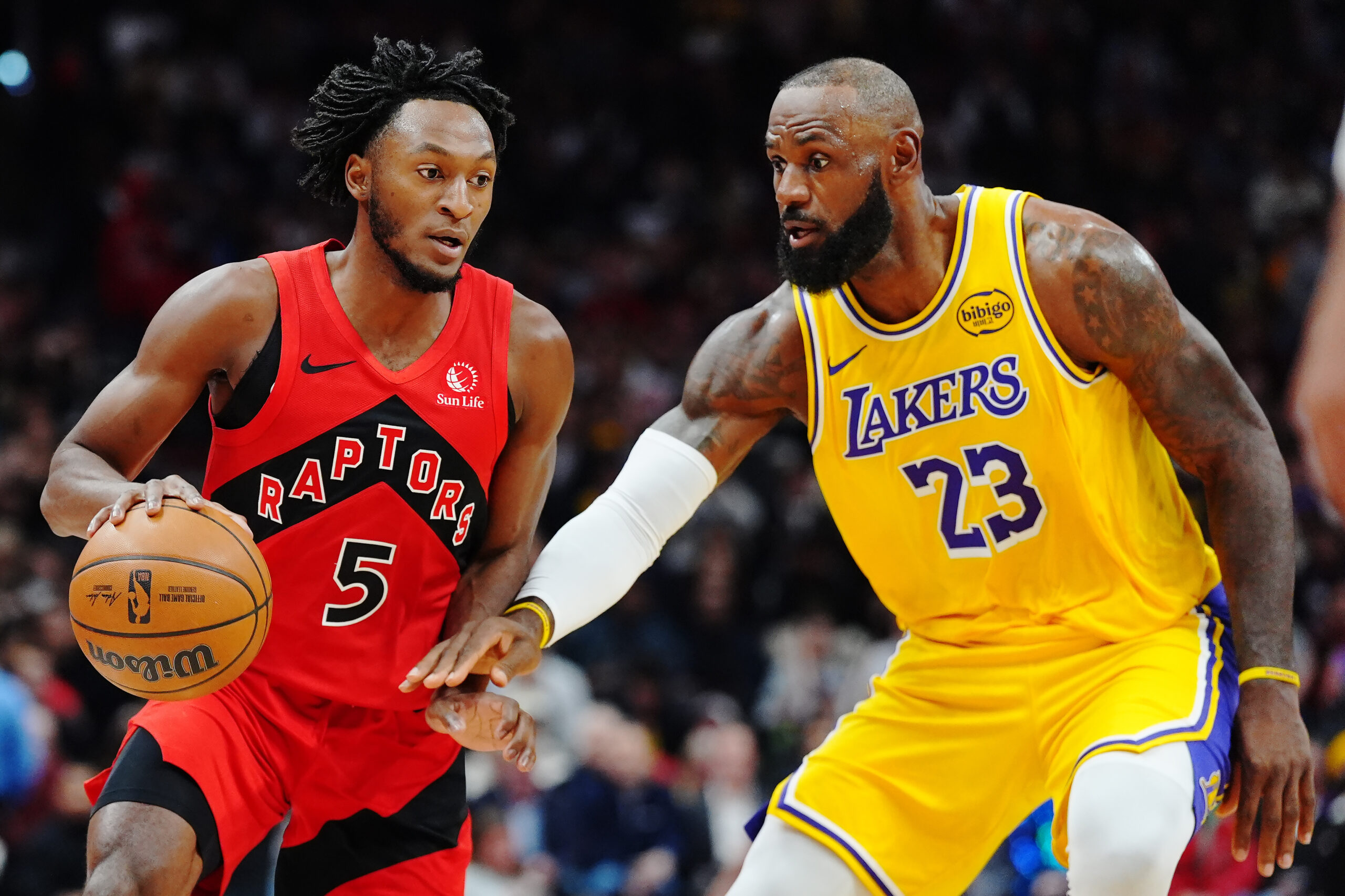 The Toronto Raptors’ Immanuel Quickley handles the ball as Lakers...