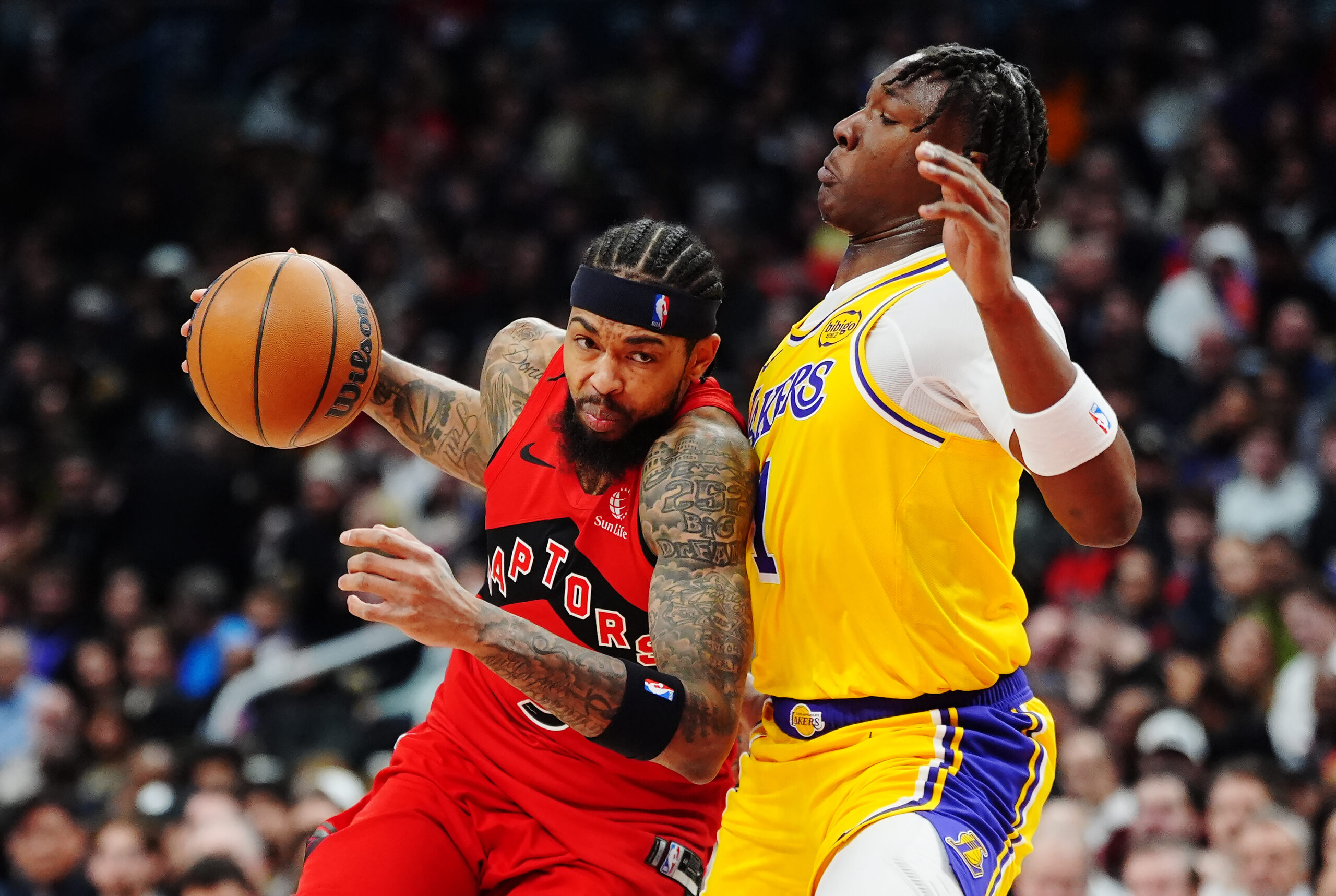 The Toronto Raptors Brandon Ingram, left, drives as Lakers rookie...