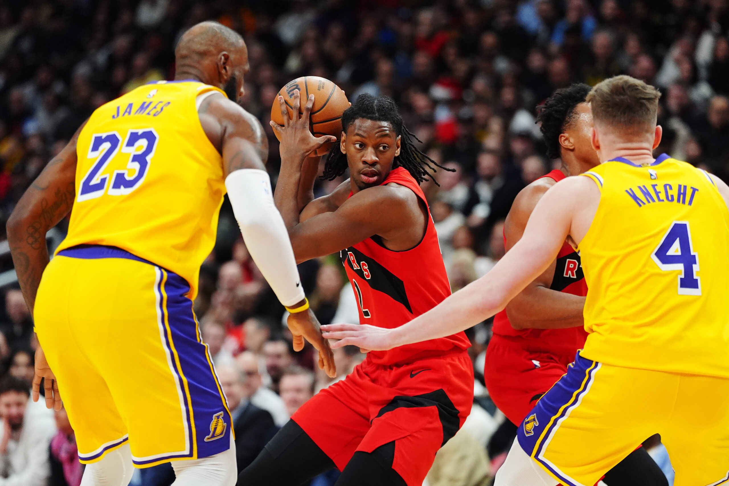 The Toronto Raptors’ Jonathan Mogbo protects the ball from the...