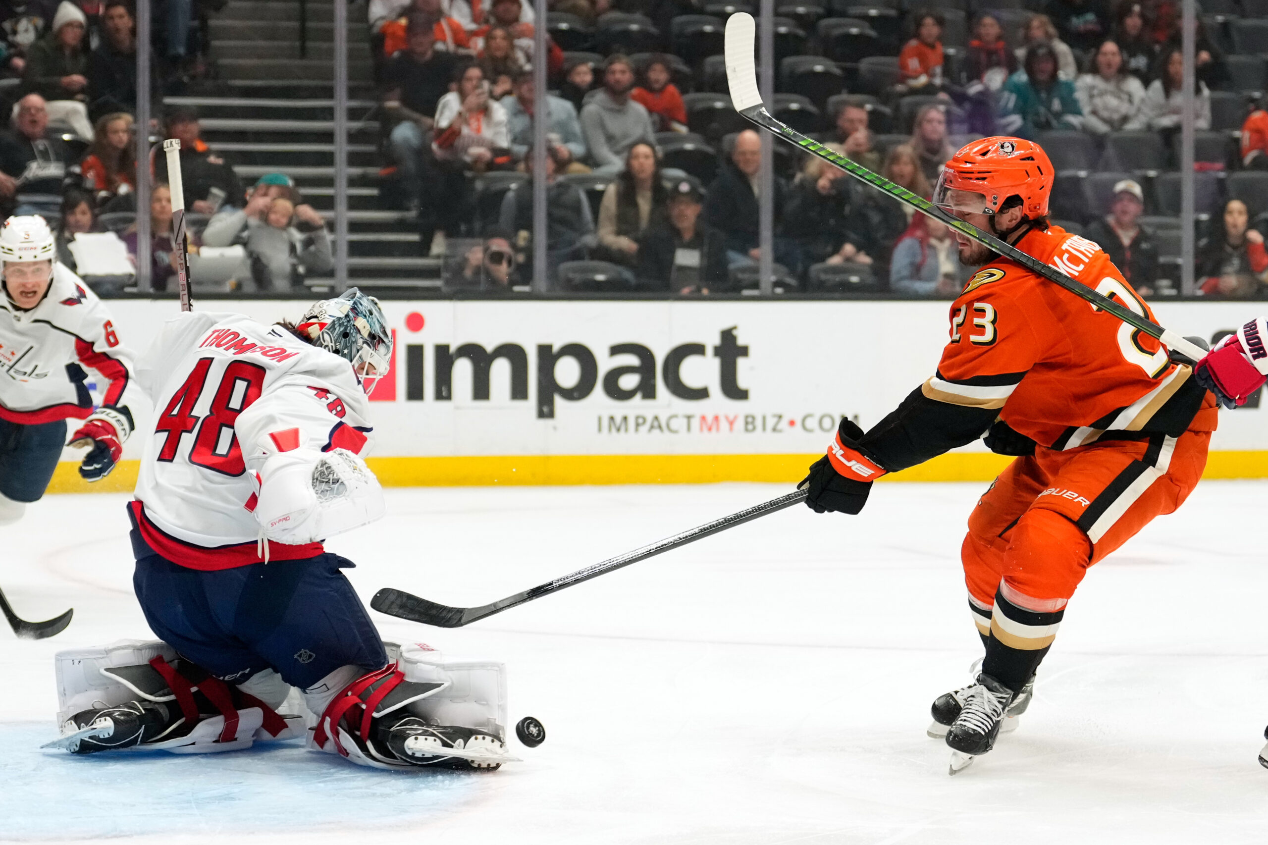 Washington Capitals goaltender Logan Thompson, left, stops a shot by...