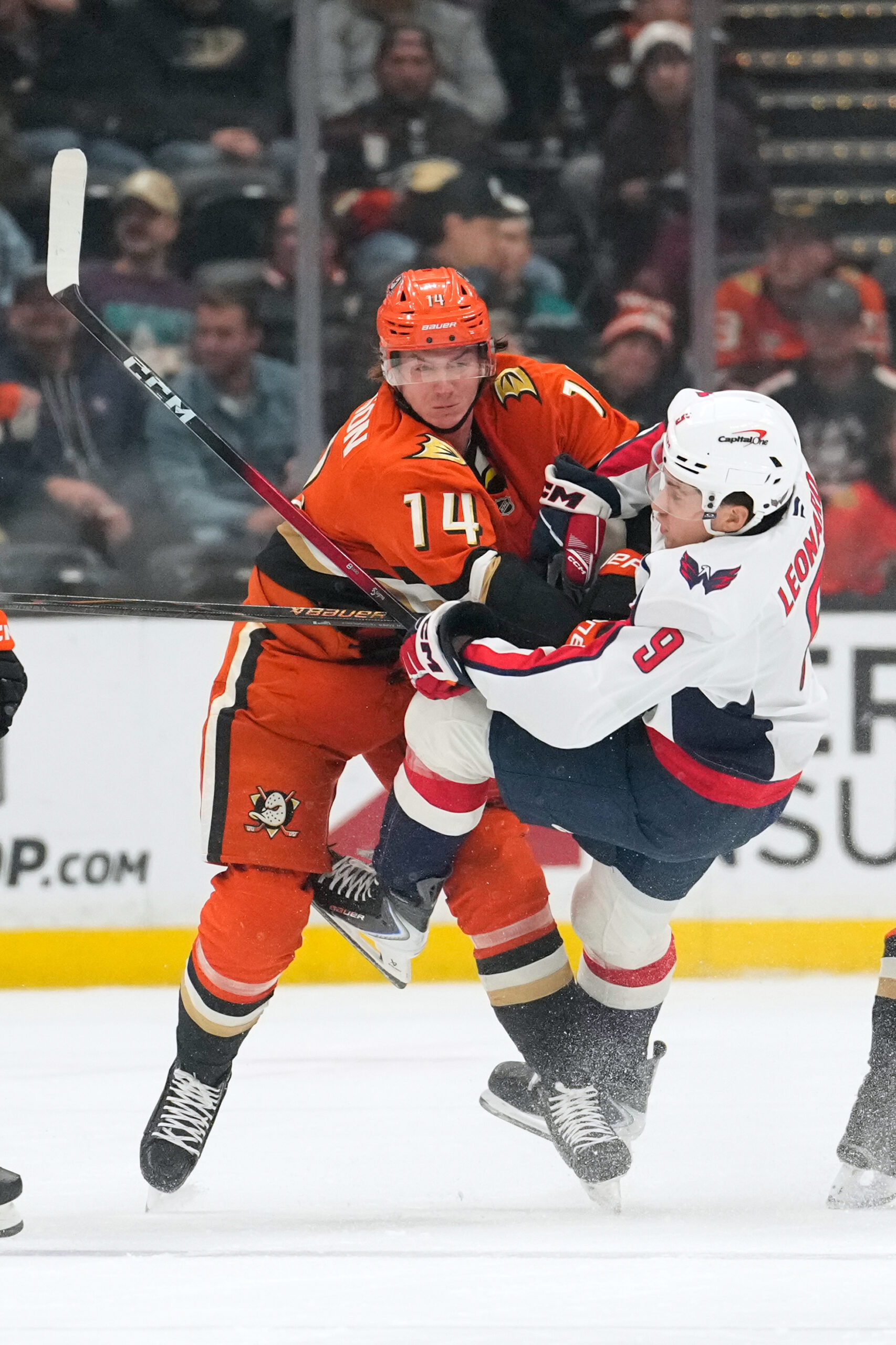Ducks defenseman Drew Helleson, left, collides with Washington Capitals right...