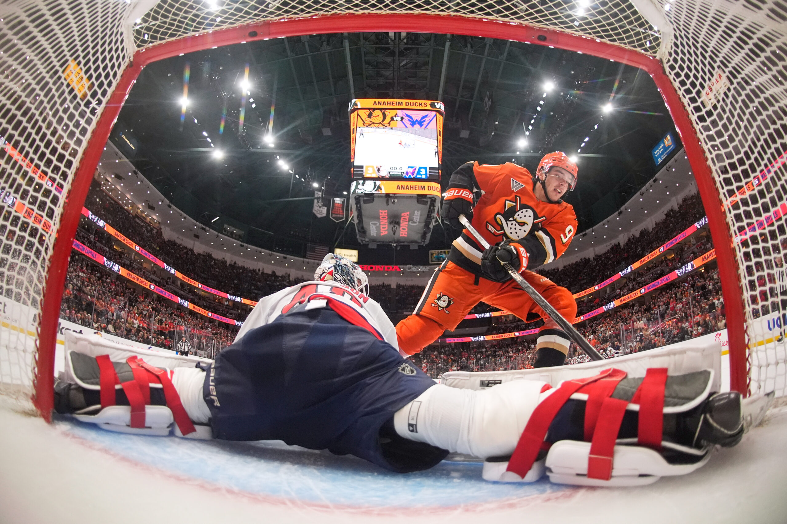 Washington Capitals goaltender Logan Thompson, left, stops a shot by...