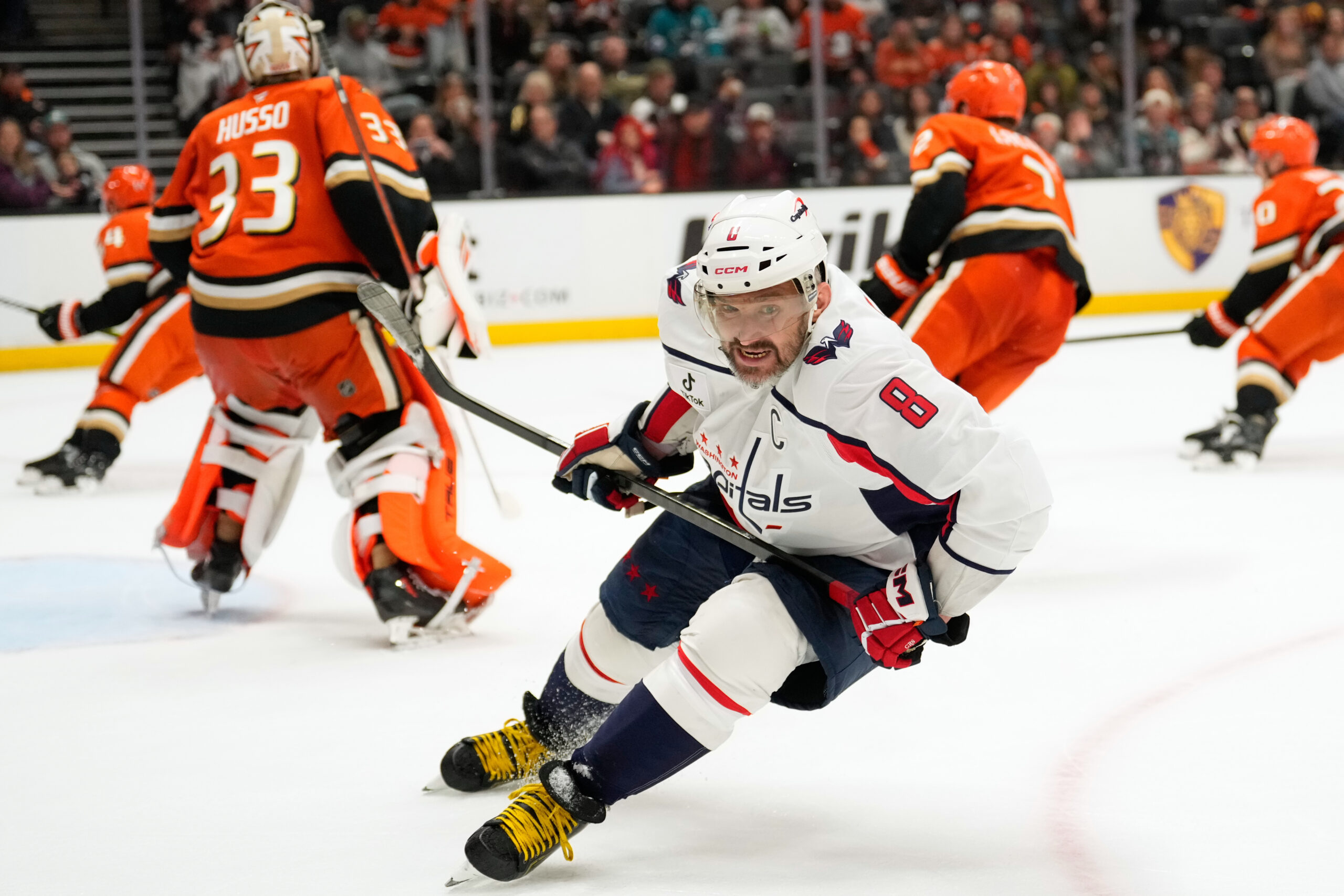 Washington Capitals left wing Alex Ovechkin, center, skates by after...