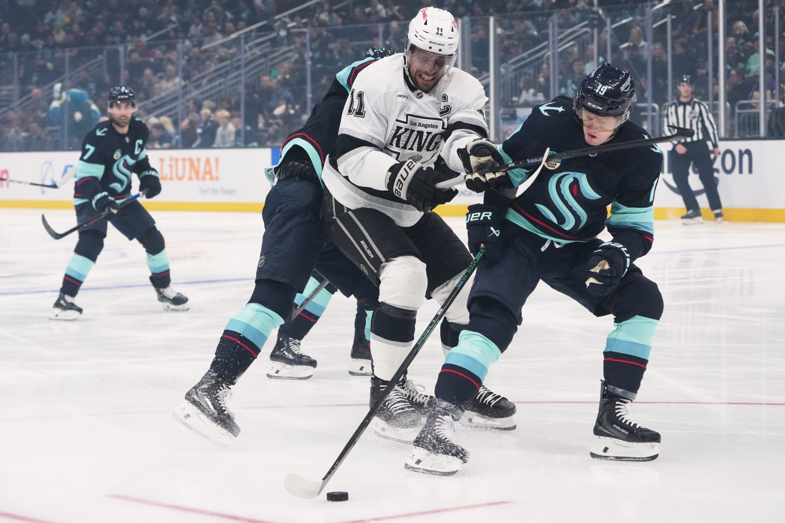 Kings center Anze Kopitar (11) collides with Seattle Kraken left...