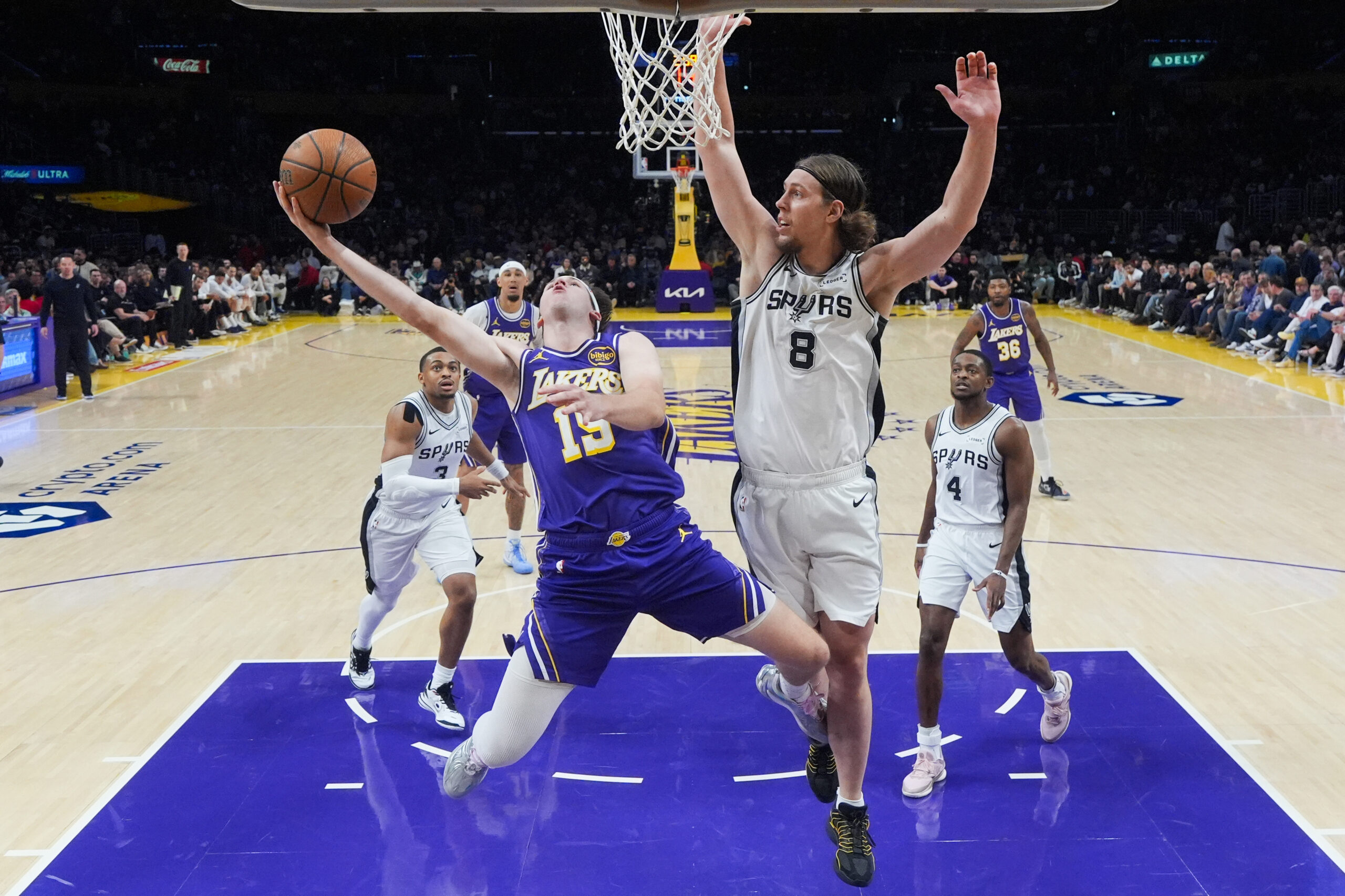 Lakers guard Austin Reaves (15) goes up for a shot...