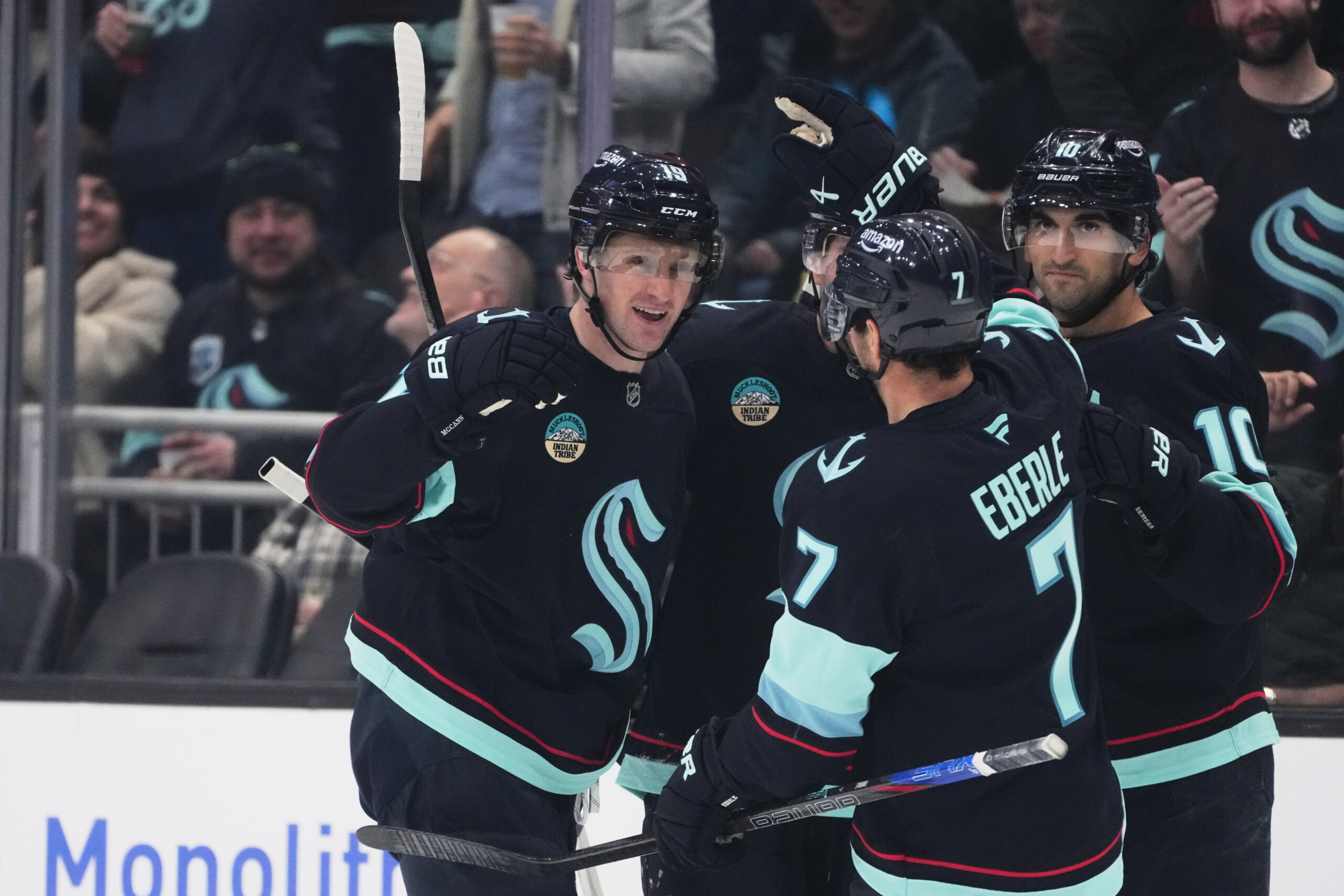 Seattle Kraken left wing Jared McCann, left, celebrates his goal...
