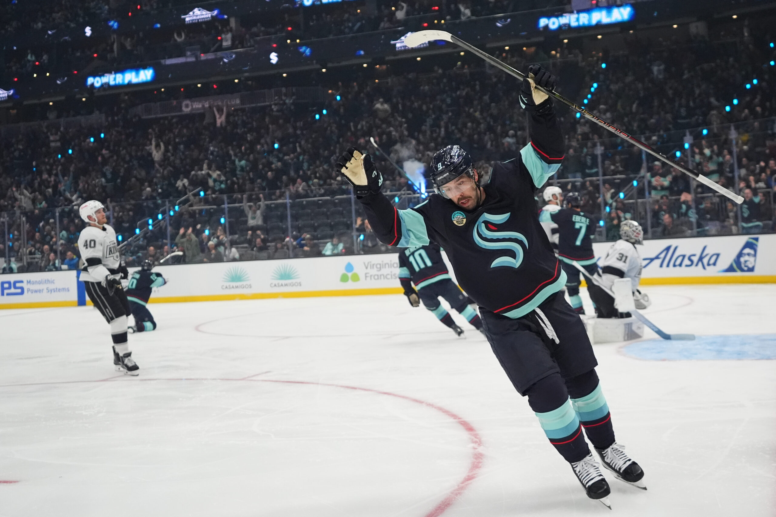 Seattle Kraken center Chandler Stephenson celebrates a goal by teammate...