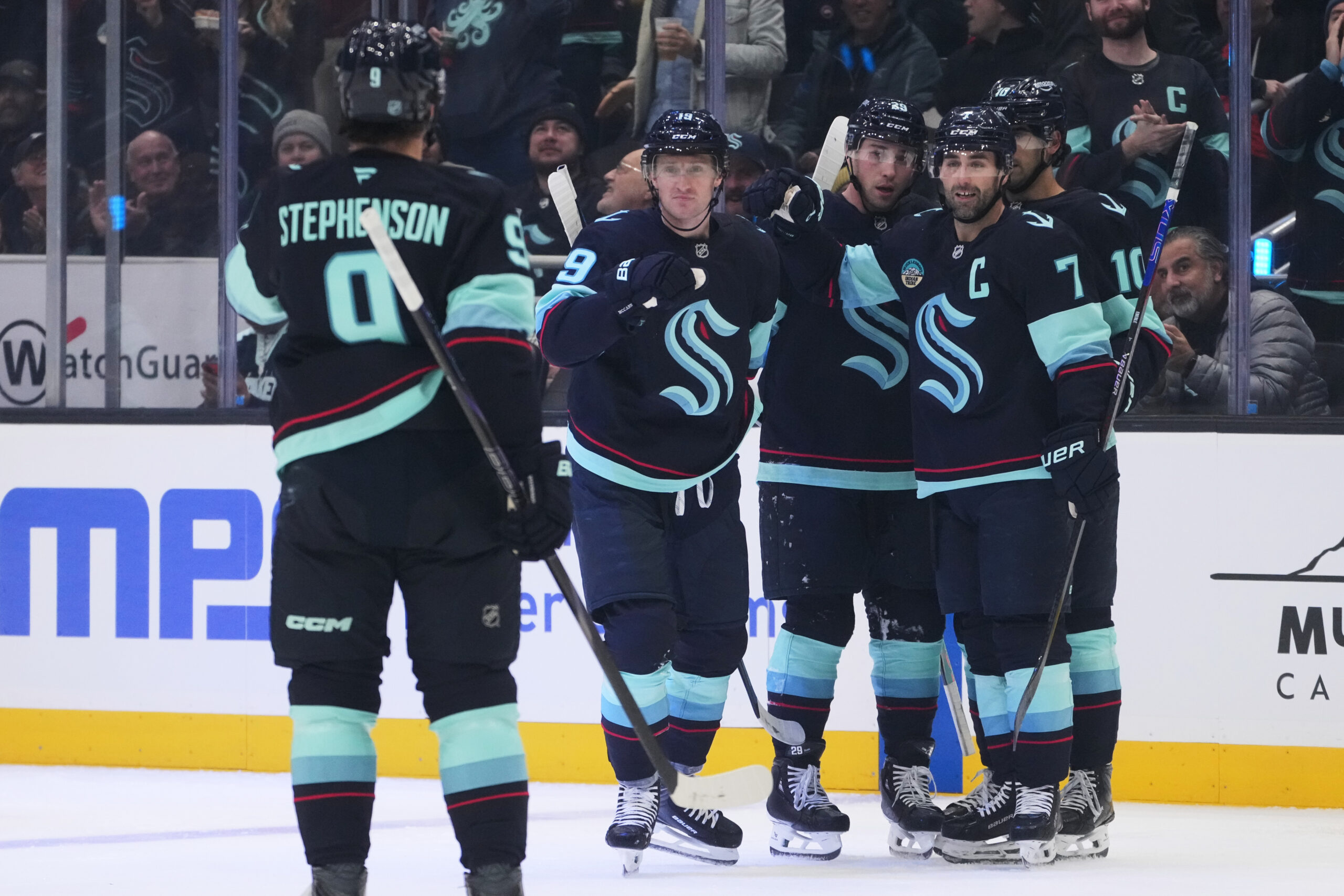 Seattle Kraken left wing Jared McCann, second from left, celebrates...