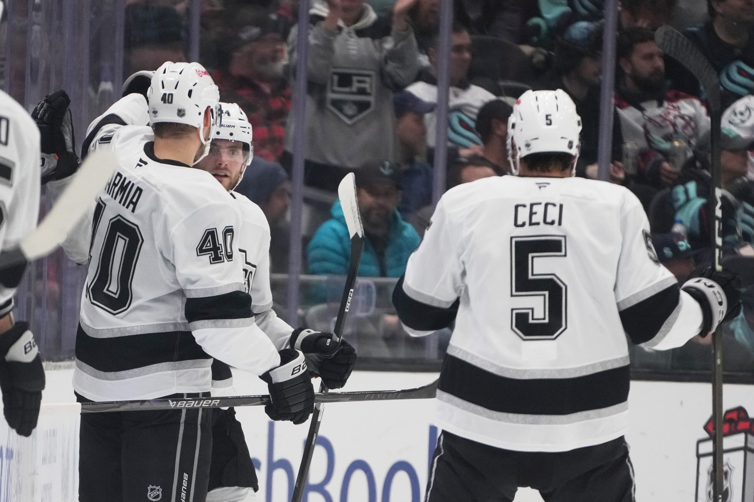 Kings right wing Alex Laferriere, second from left, celebrates his...