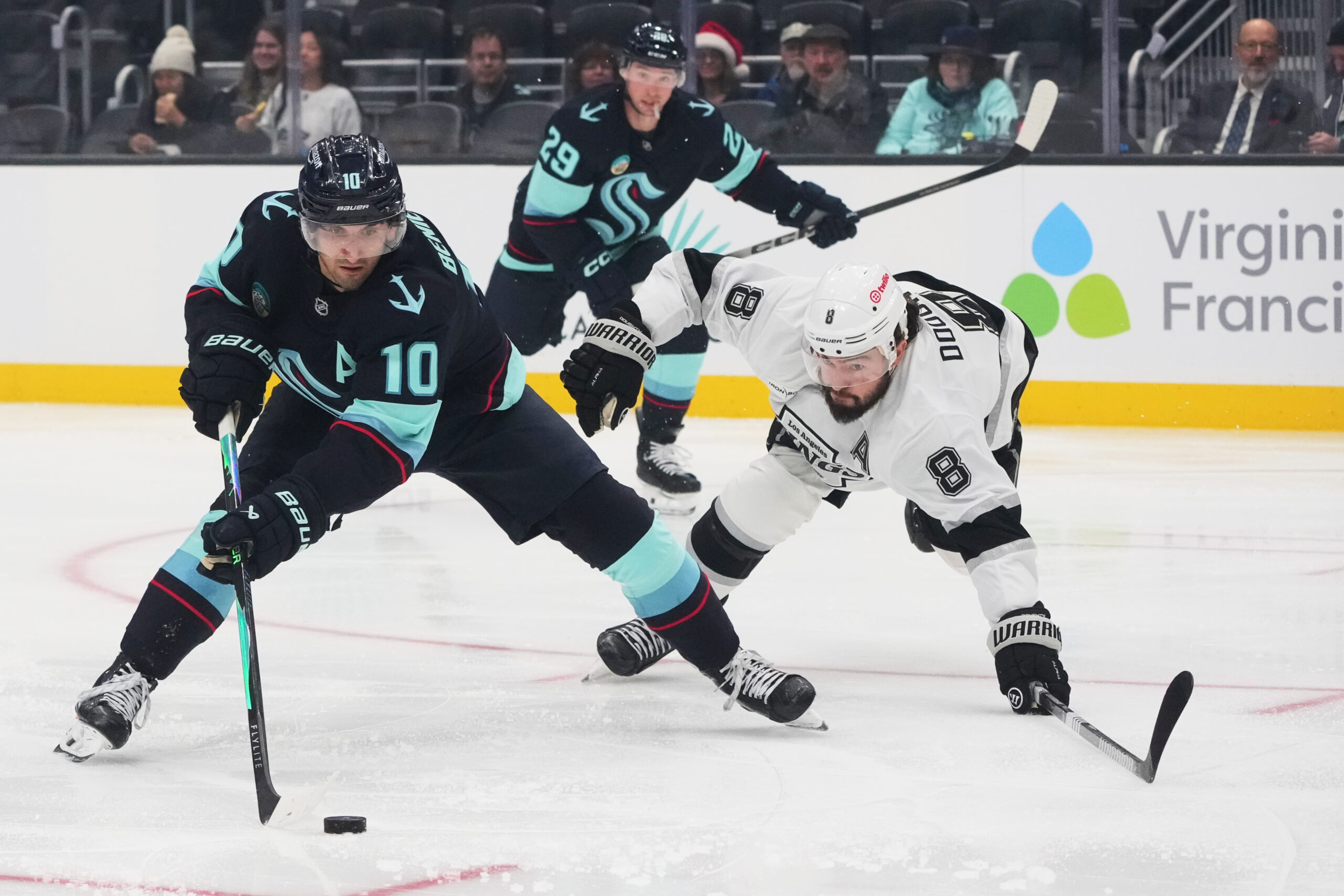 Seattle Kraken center Matty Beniers (10) tries to maneuver around...