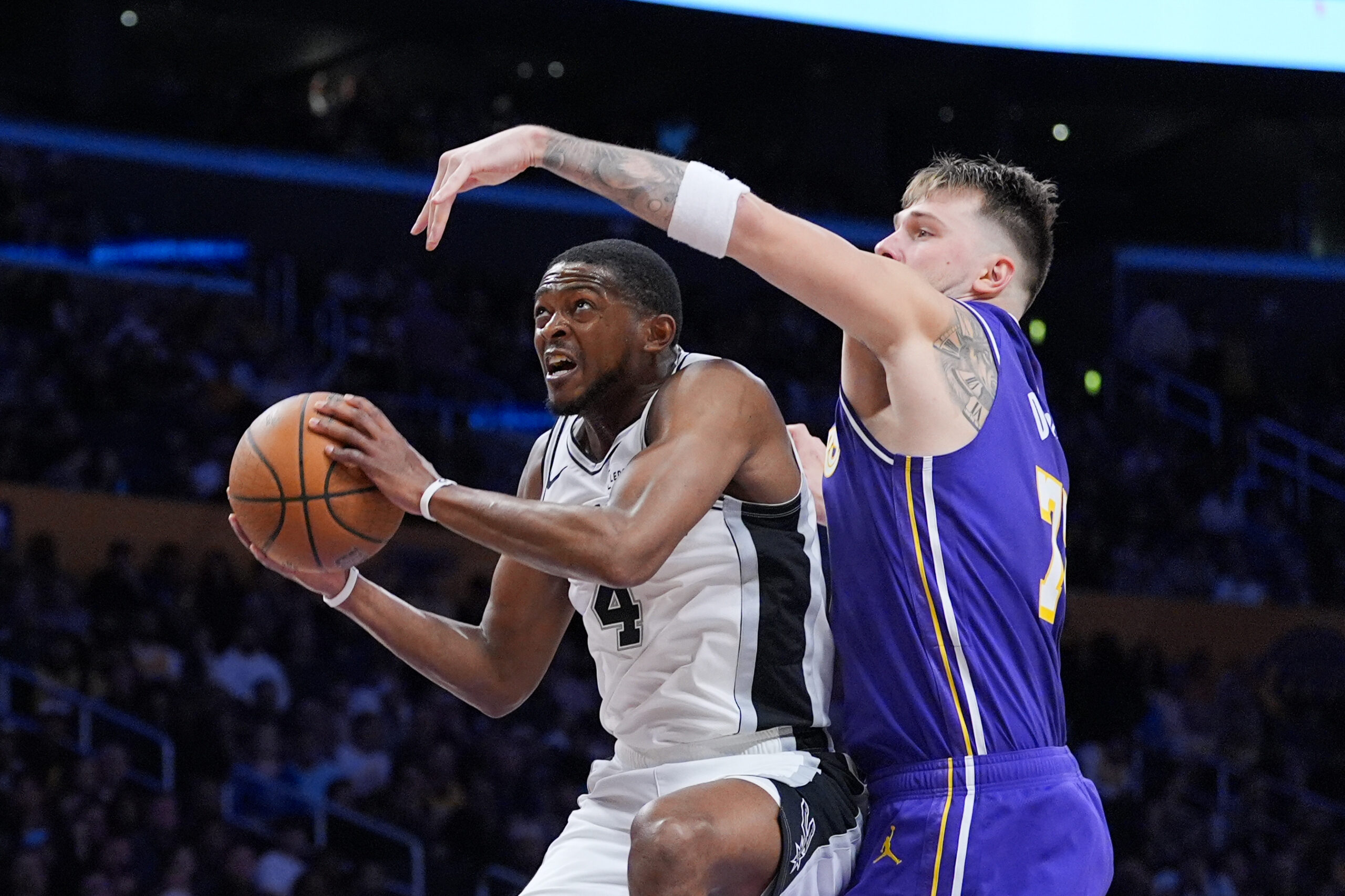 San Antonio Spurs guard De’Aaron Fox drives as Lakers star...