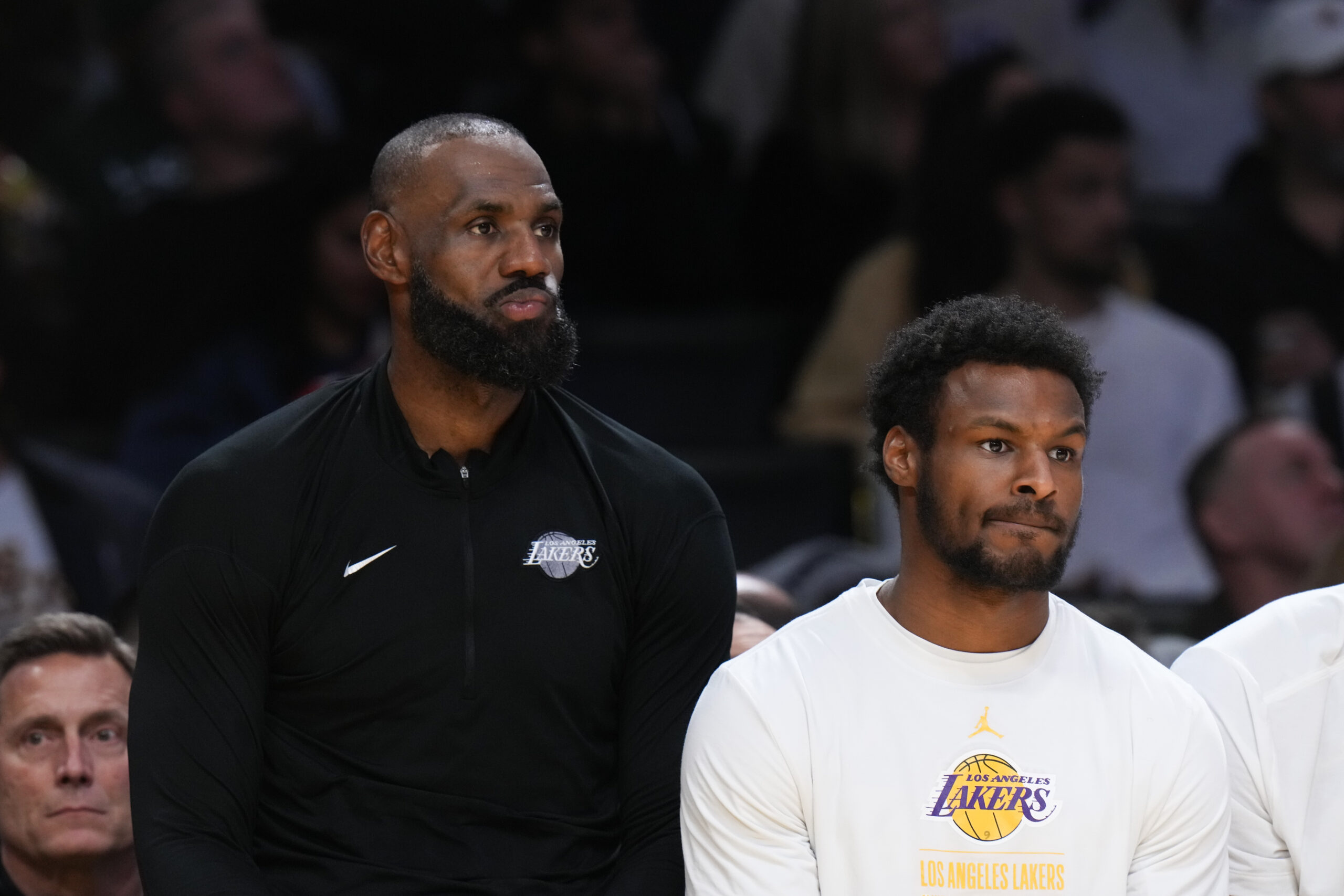 Lakers forward Lebron James, left, and guard Bronny James sit...