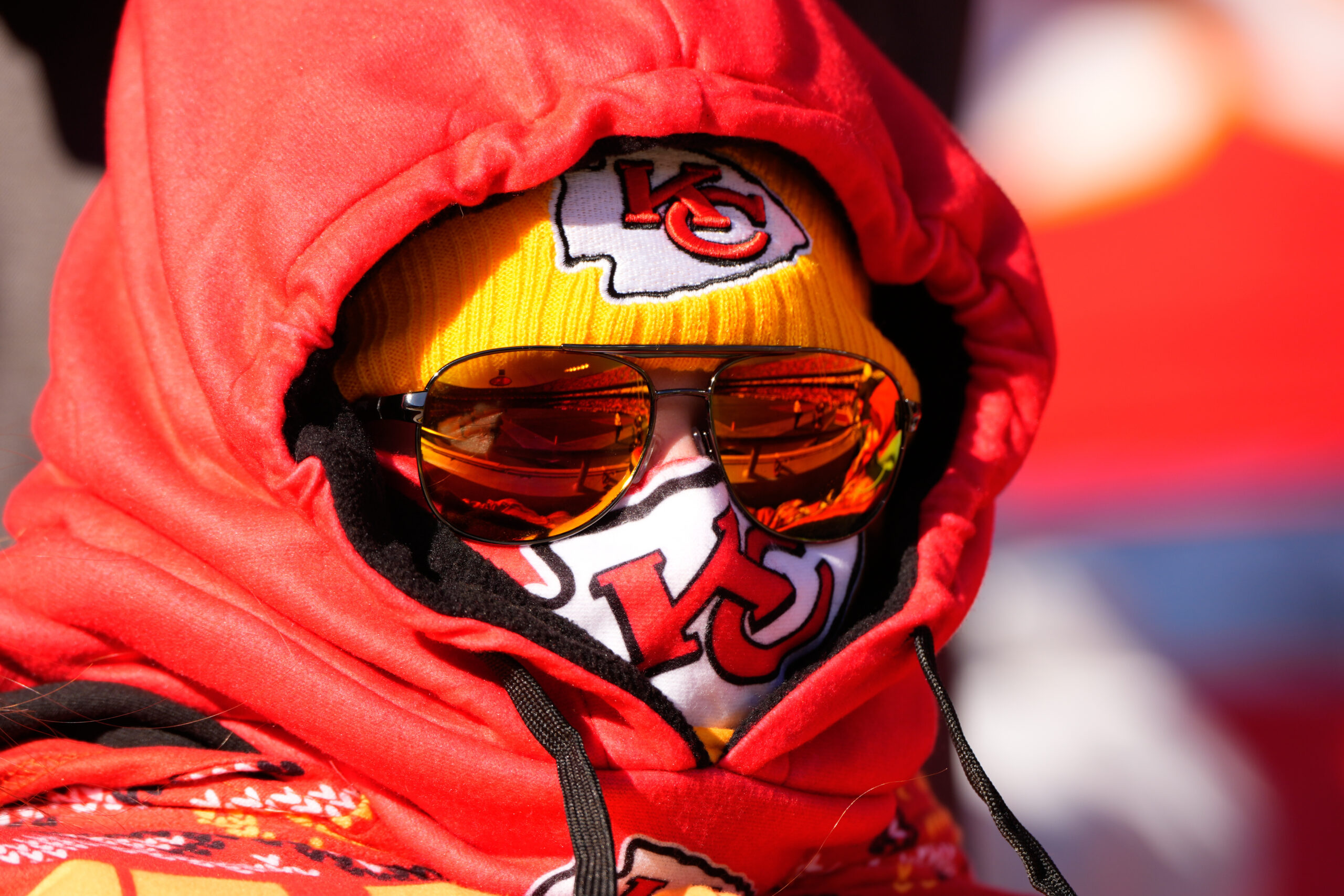 A Kansas City Chiefs fan is bundled up for the...