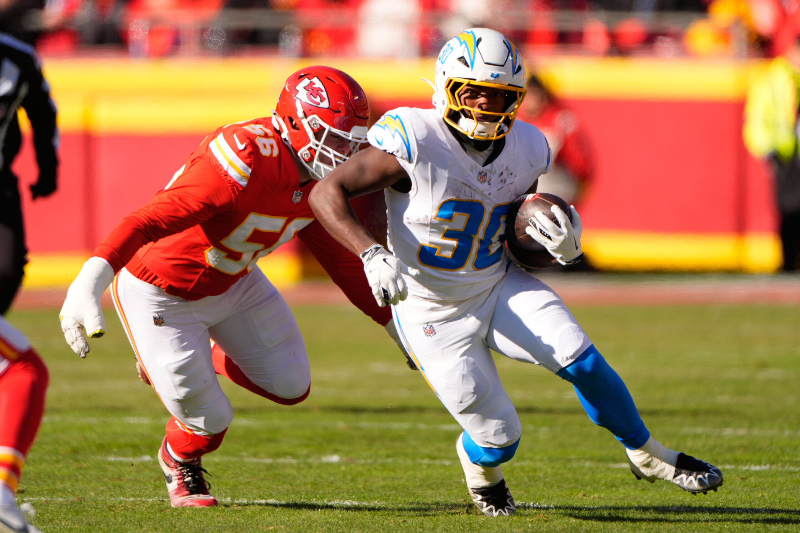 Chargers running back Kimani Vidal (30) runs with the ball...