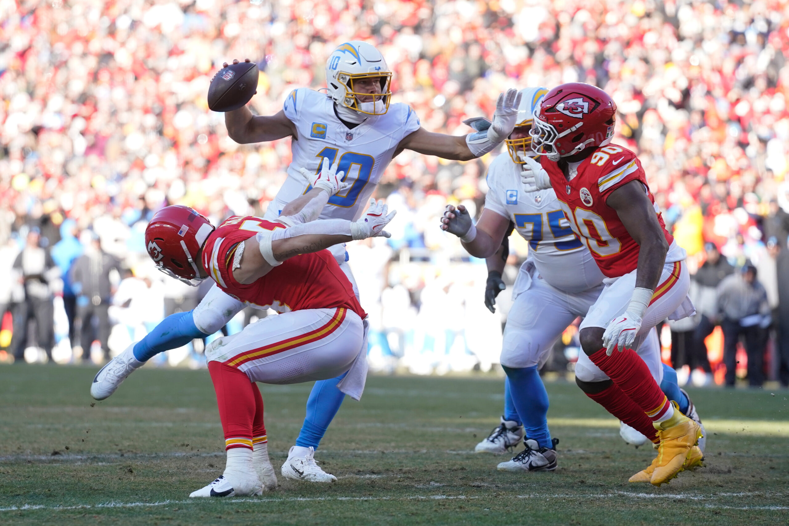 Chargers quarterback Justin Herbert (10) scrambles as Kansas City Chiefs...