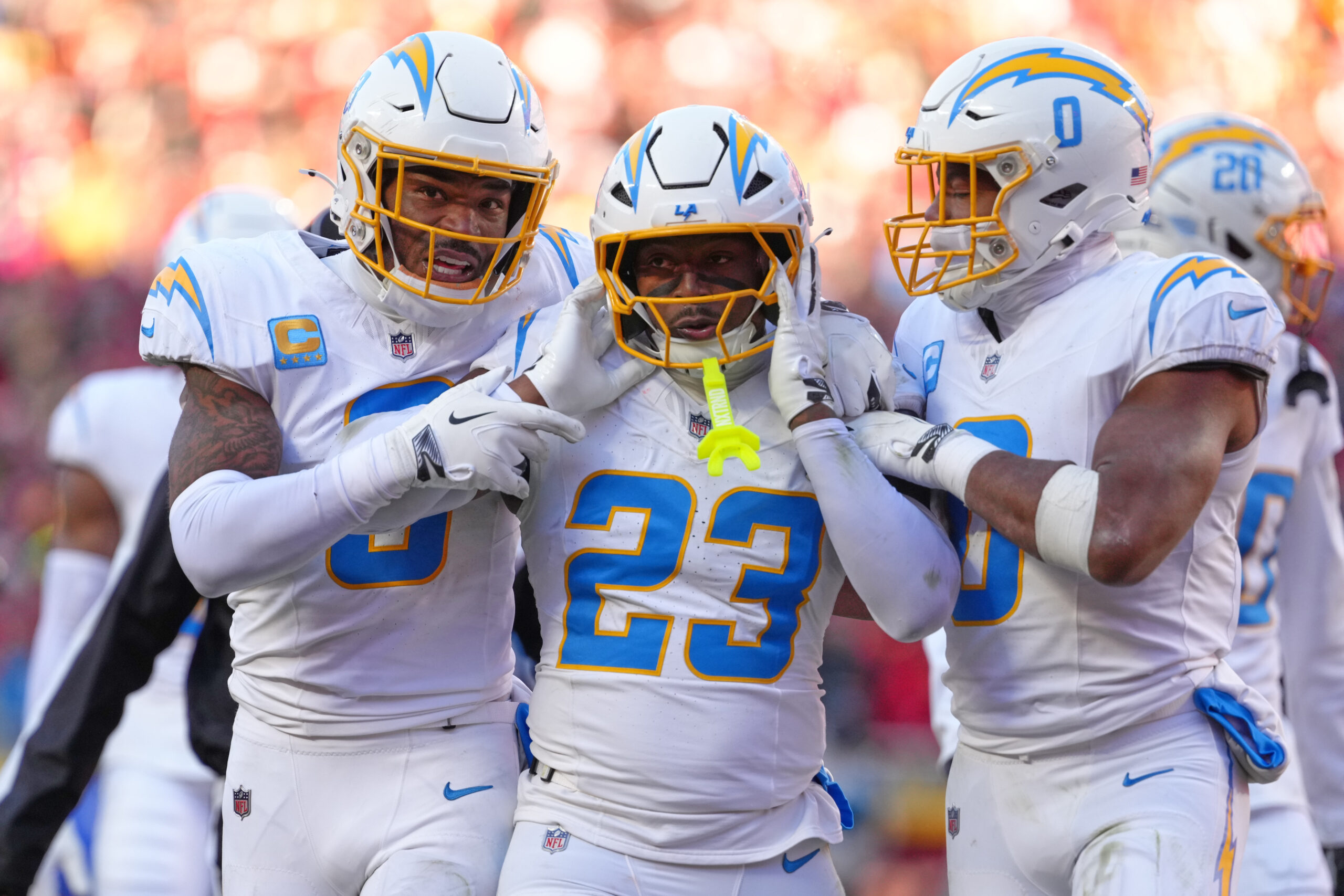 Chargers safety Tony Jefferson (23) is held by teammates Derwin...