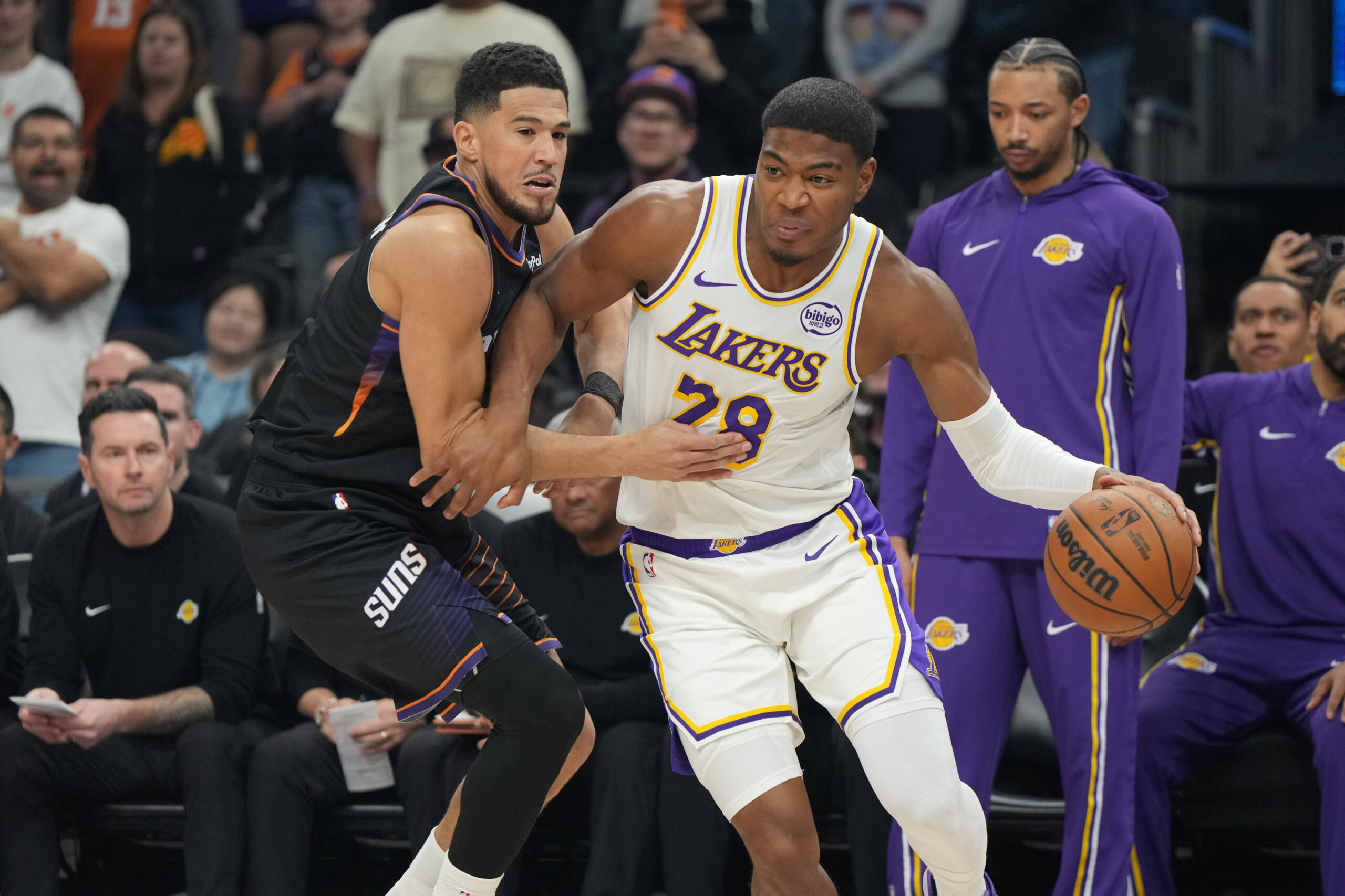 Lakers forward Rui Hachimura, center right, drives against Phoenix Suns...
