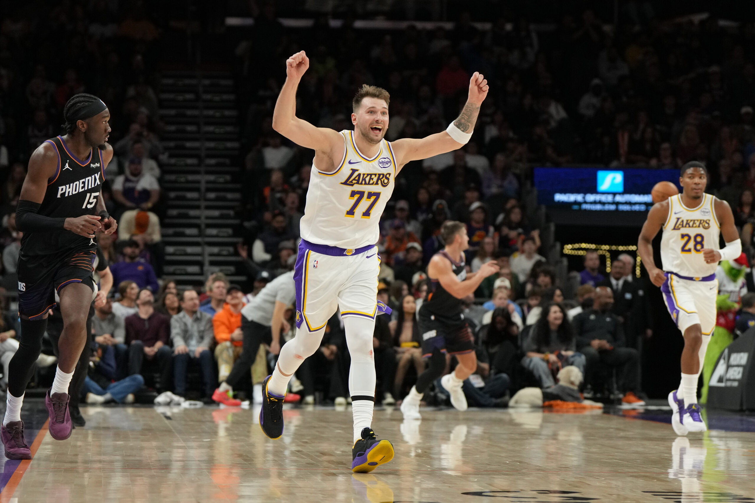 Lakers guard Luka Doncic (77) reacts after scoring against the...