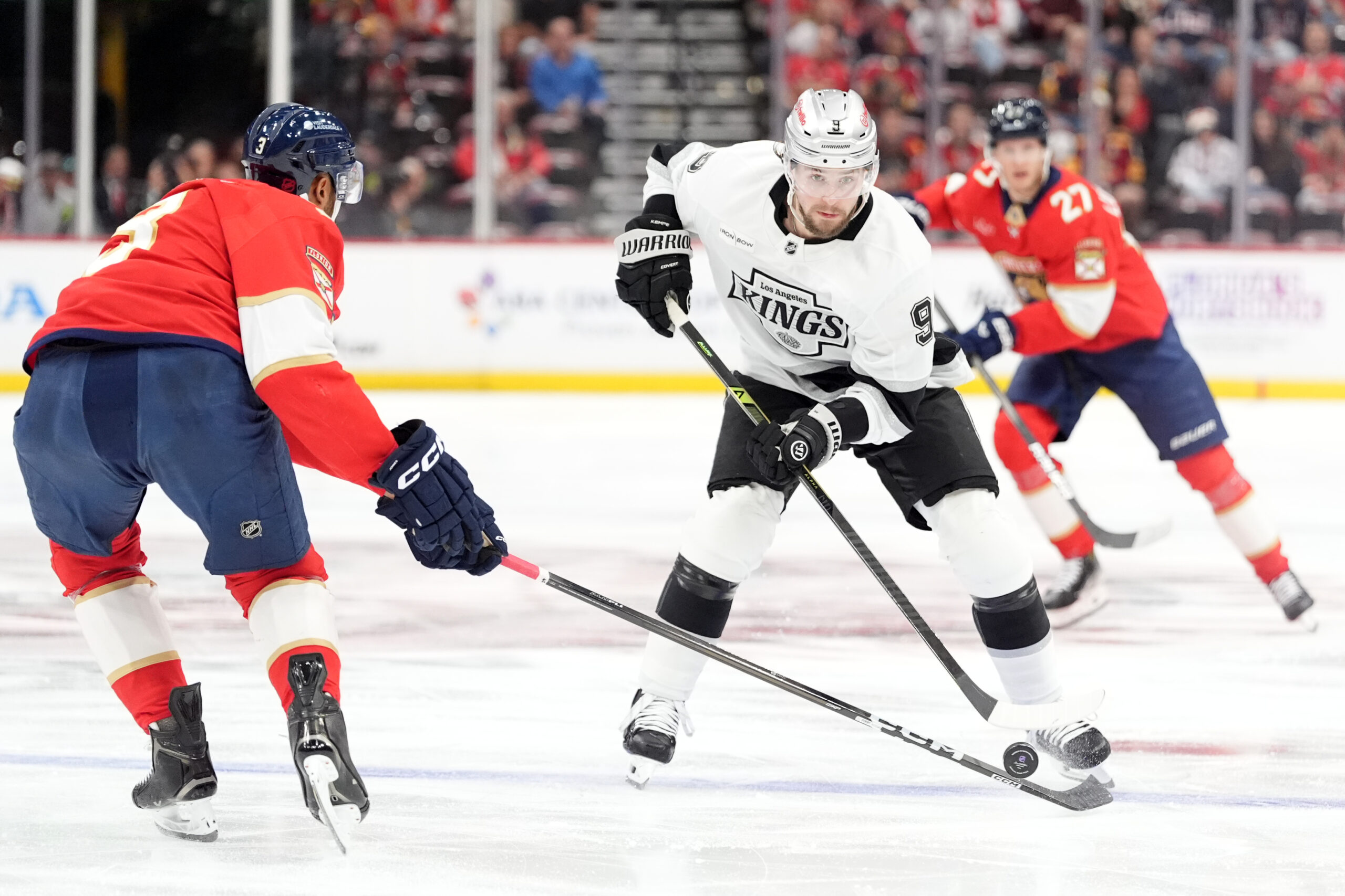 Kings right wing Adrian Kempe, right, tries to pass the...