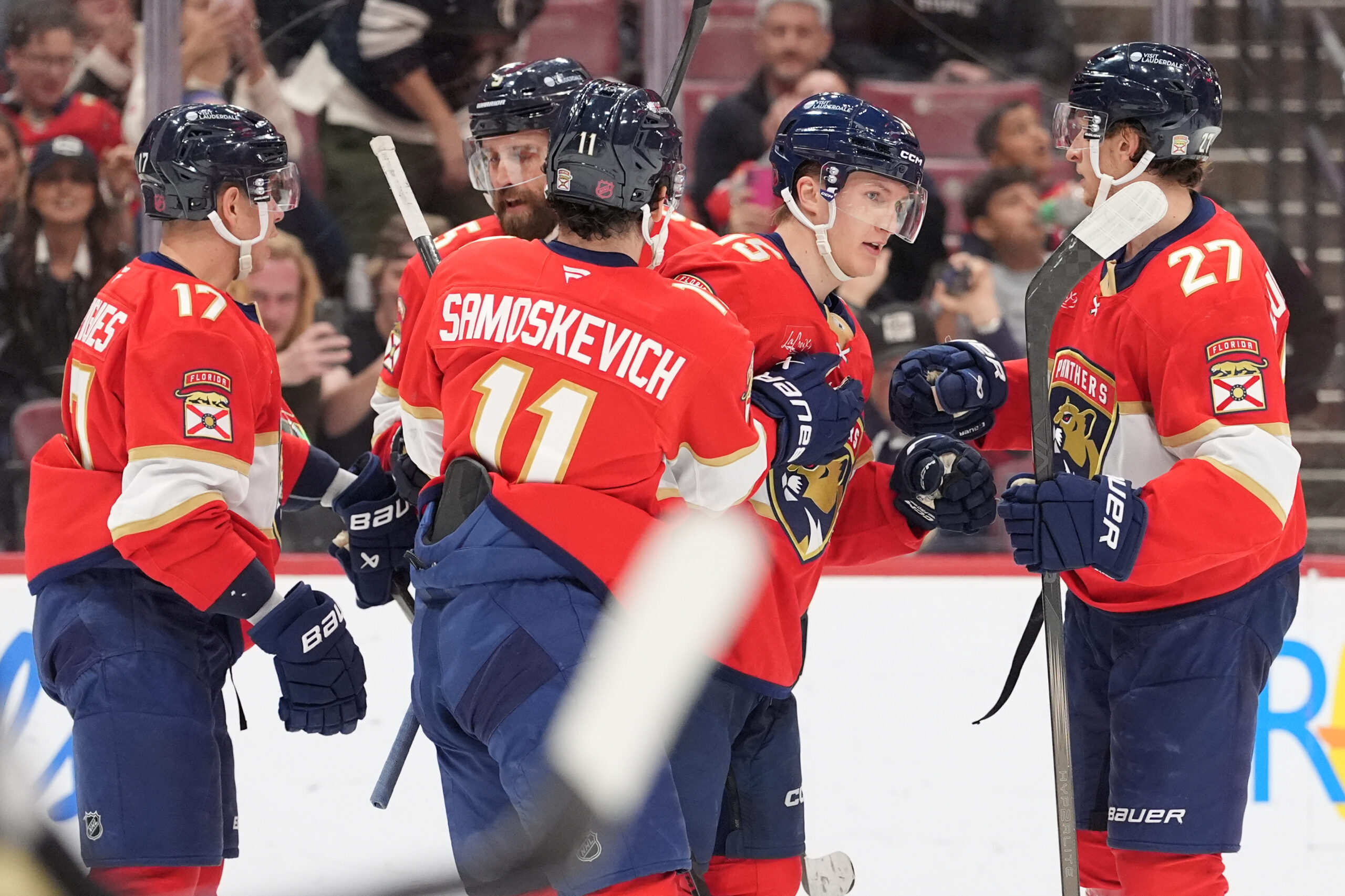 Florida Panthers center Anton Lundell (15) is congratulated by teammates...