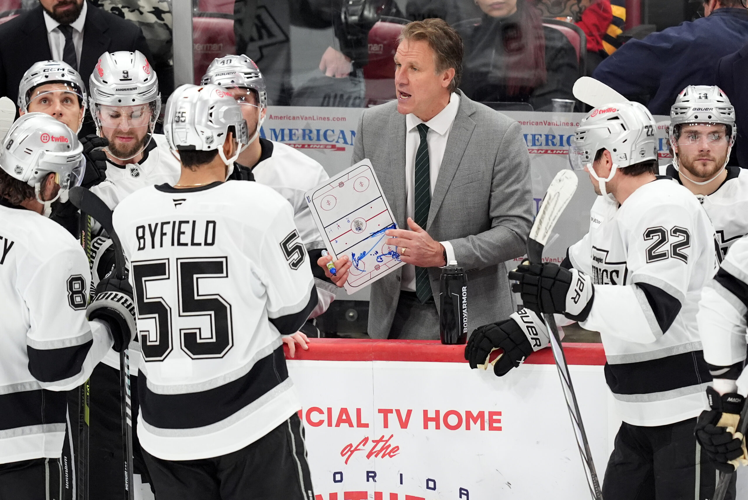 Kings head coach Jim Hiller talks to his players during...